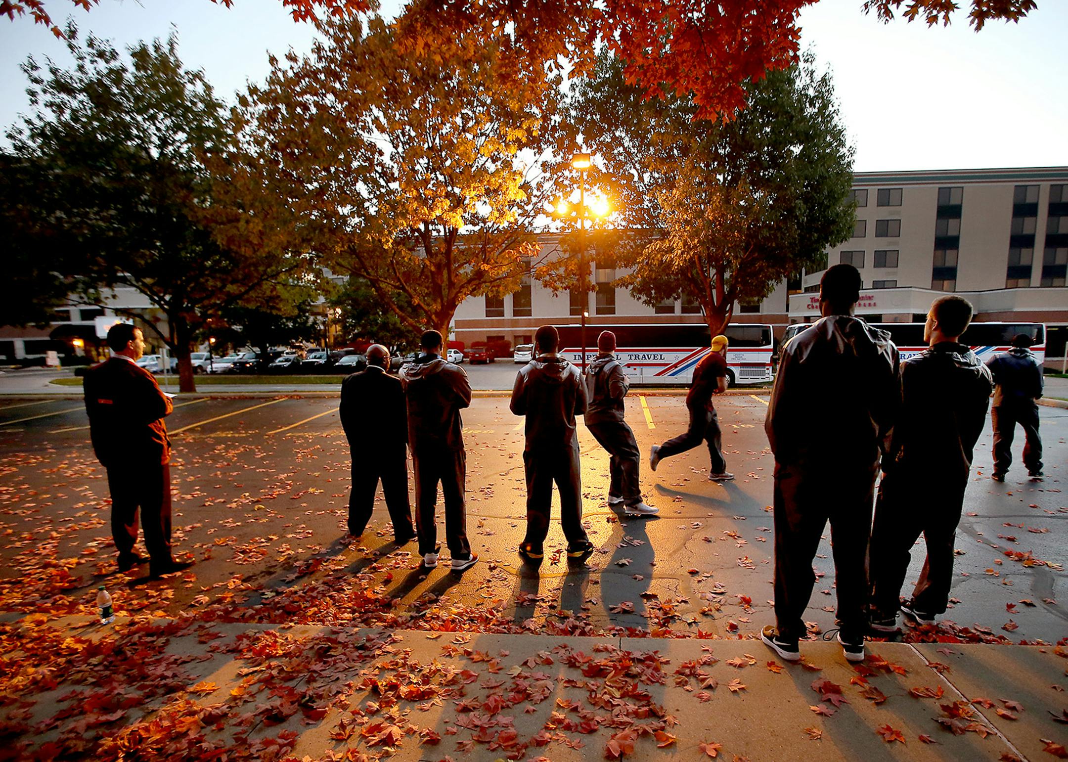 7:08 a.m. Saturday: Quarterback Mitch Leidner, center, worked on a pass play during the team’s walk-through in a parking lot across the street from the team hotel in Champaign, Ill.