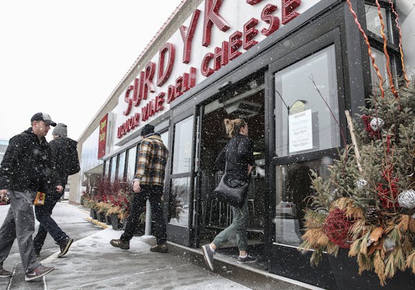 People enter Surdyk's in the snow on Sunday, March 12. Surdyk's, opened for business Sunday, despite Minnesota&#x2019;s new Sunday liquor sales law no