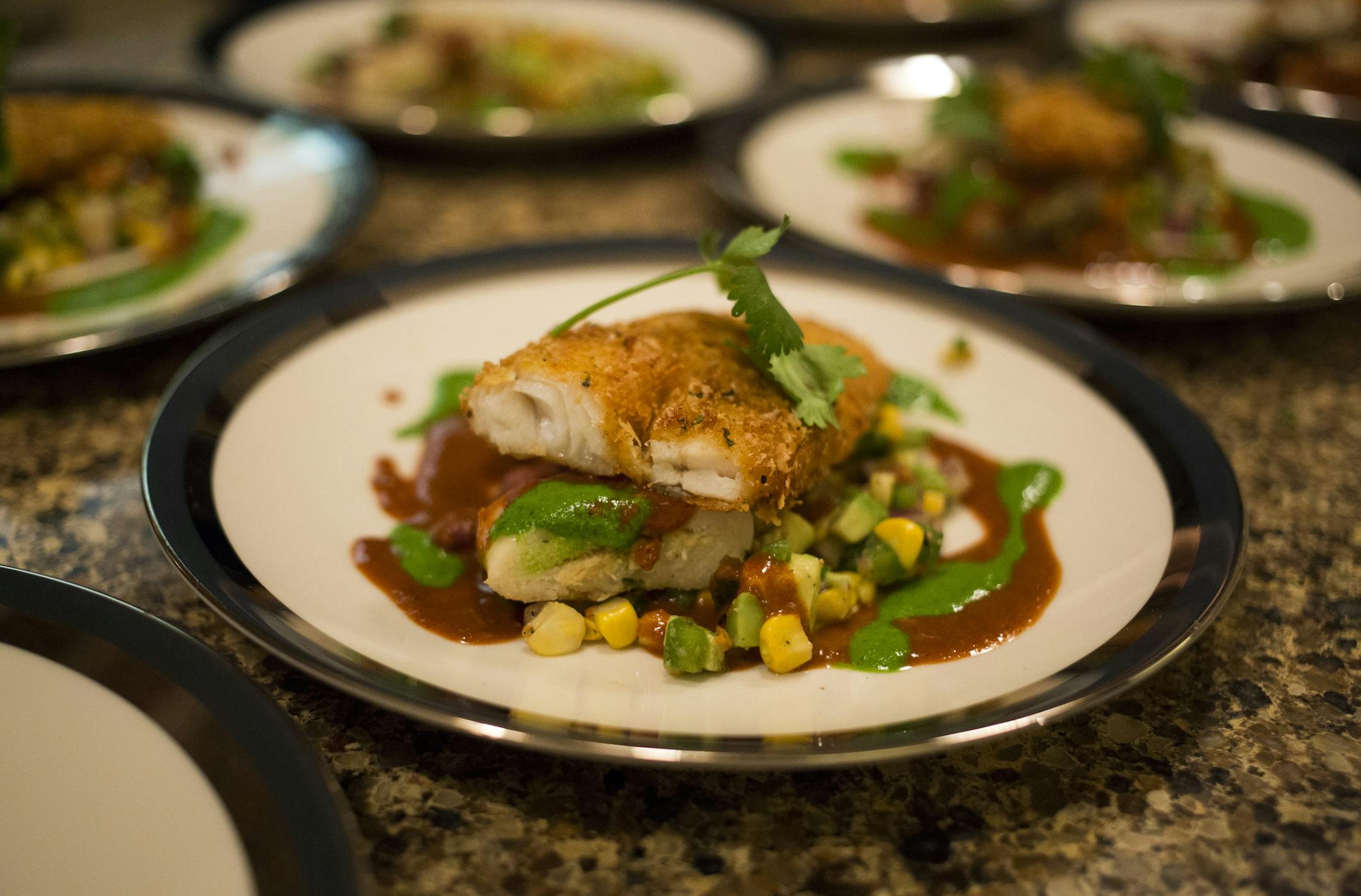 Walleye & Wild Turkey Tamales, Red Mole & Avocado Salsa - Chef Jim Kyndberg prepared a wild game feast for Outdoor TV personality Ron Schara and guests. ] BRIAN PETERSON • brianp@startribune.com Ramsey, MN - 2/25/2015