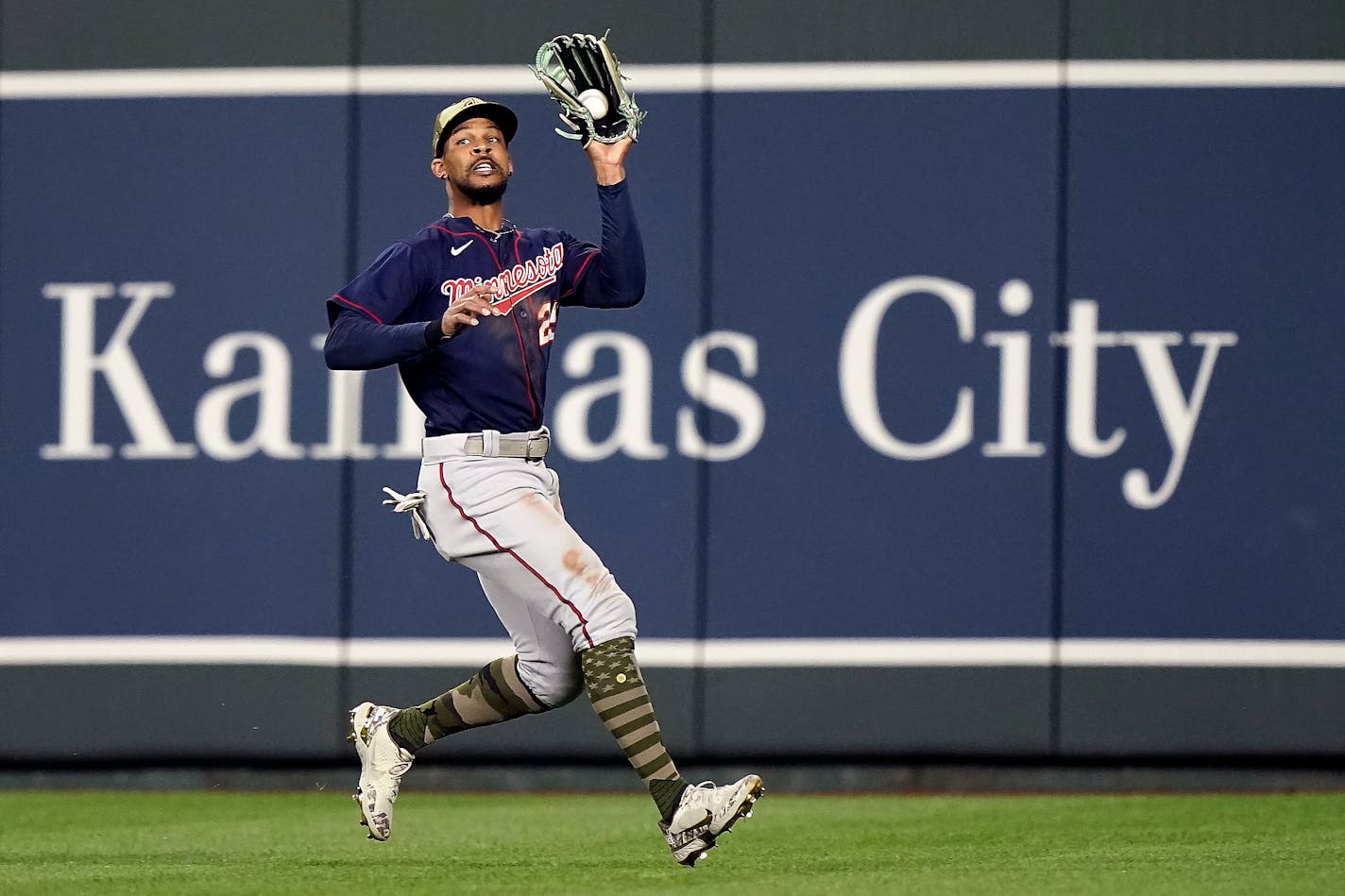 Minnesota Twins center fielder Byron Buxton catches a ball for the out on a sacrifice fly hit by Kansas City Royals' Whit Merrifield during the seventh inning of a baseball game Friday, May 20, 2022, in Kansas City, Mo. (AP Photo/Charlie Riedel)