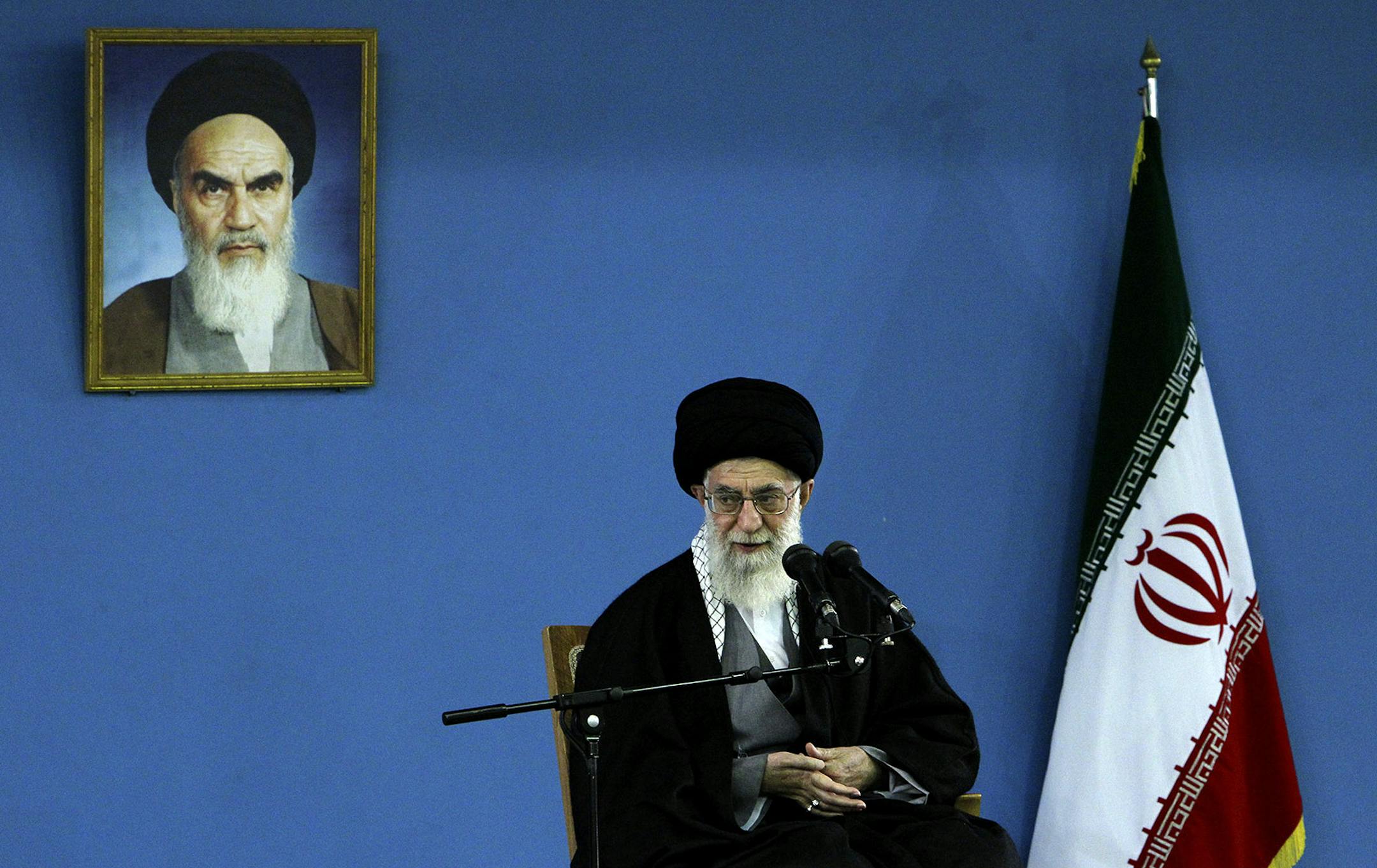 In this picture released by an official website of the office of the Iranian supreme leader, Supreme Leader Ayatollah Ali Khamenei delivers a speech under a picture of the late revolutionary founder Ayatollah Khomeini, in Tehran, Iran, Monday, Feb. 17, 2014. Iran's top leader backs the continuation of nuclear negotiations with the West but says he doubts they will succeed. (AP Photo/Office of the Iranian Supreme Leader)