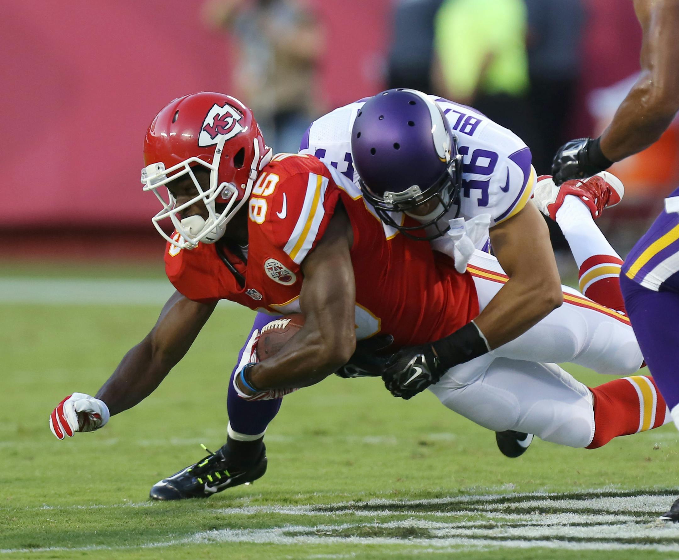 Kansas City Chiefs wide receiver Frankie Hammond (85) is tackled by Minnesota Vikings safety Robert Blanton (36) during the first half of an NFL preseason football game in Kansas City, Mo., Saturday, Aug. 23, 2014. (AP Photo/Ed Zurga) ORG XMIT: MONH1
