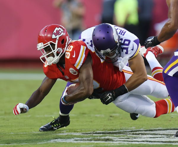 Kansas City Chiefs wide receiver Frankie Hammond (85) is tackled by Minnesota Vikings safety Robert Blanton (36) during the first half of an NFL prese