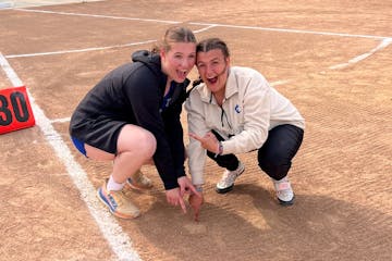 Cambridge-Isanti shot putters Evelyn Wiltrout (left) and Erin Baker posed over the mark Wiltrout’s shot made on her winning throw at the Mississippi