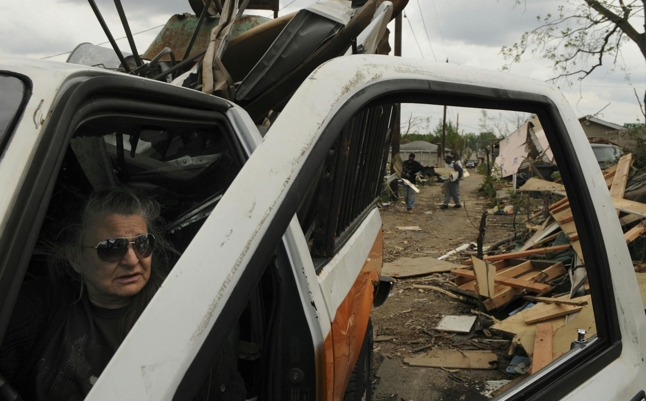 Nancy Luken of South Minneapolis was hauling away scrap metal from the tornado ravaged North Minneapolis. She was in an alley near Logan Ave N and 30th St.