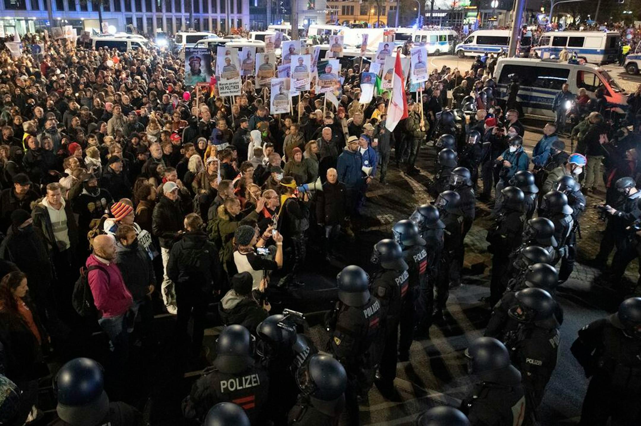 People gather during a demonstration of the Stuttgart initiative "Lateral Thinking" in Leipzig, Germany, Saturday, Nov. 7, 2020.