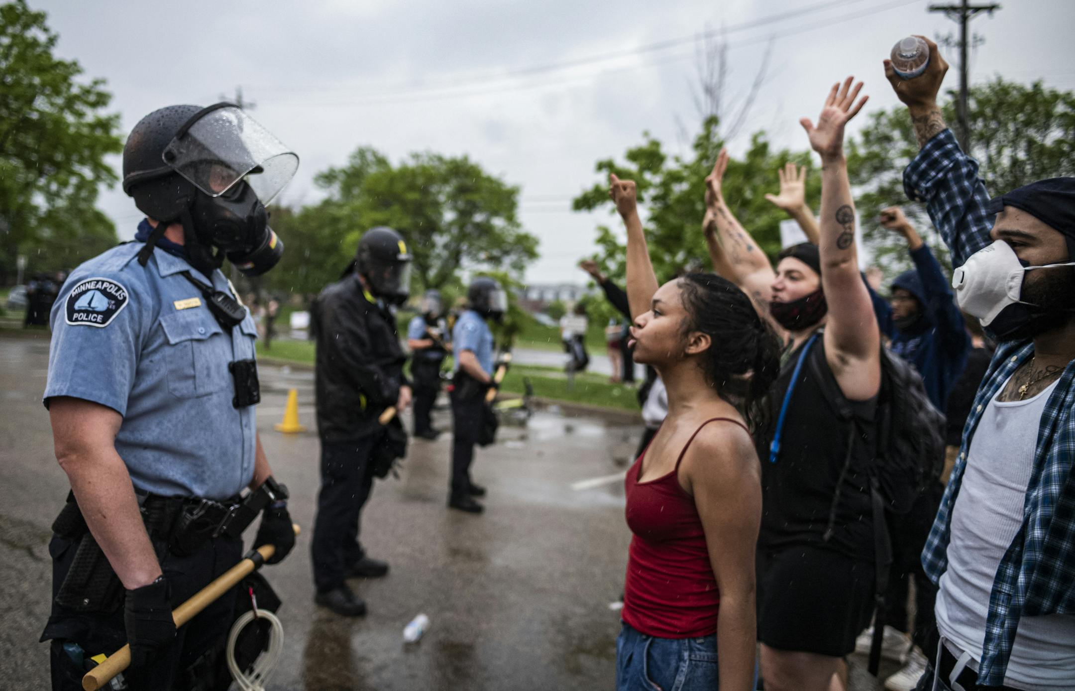 Protesters and police face each other during a rally against the death of George Floyd in Minneapolis on Tuesday, May 26, 2020. Four Minneapolis officers involved in the arrest of the black man who died in police custody were fired Tuesday, hours after a bystander's video showed an officer kneeling on the handcuffed man's neck, even after he pleaded that he could not breathe and stopped moving. (Richard Tsong-Taatarii/Star Tribune via AP)