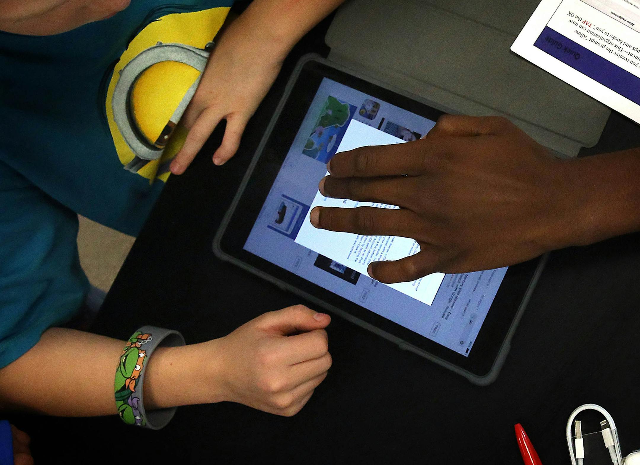 Harding High School junior and National Honor Society member Marcelus Ifonlaja (right), helped Parkway Middle School sixth grader Brice Roozen set up his iPad. ]JIM GEHRZ &#x201a;&#xc4;&#xa2; jgehrz@startribune.com / St. Paul, MN / Oct. 7, 2014 / 4:00 PM / BACKGROUND INFORMATION: In a low key rollout, the St. Paul School District's grand experiment with iPads begins quietly Tuesday when students at Parkway Middle School become the first in the district to pick up the high tech equipment. Student