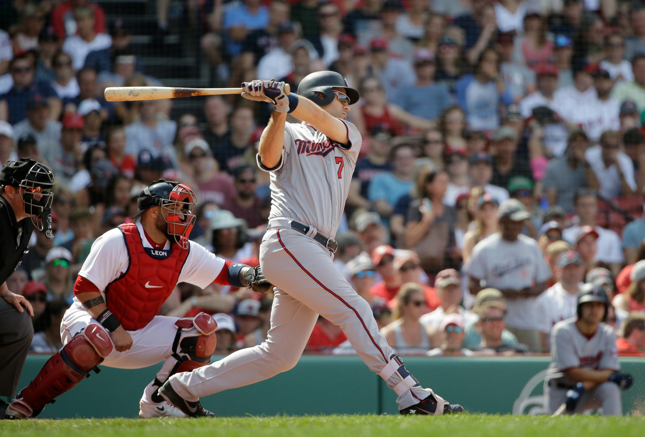 Minnesota Twins' Joe Mauer swings at a pitch as Boston Red Sox's Sandy Leon, left, looks on in the ninth inning of a baseball game, Sunday, July 29, 2018, in Boston. The Red Sox shut out the Twins 3-0. (AP Photo/Steven Senne)
