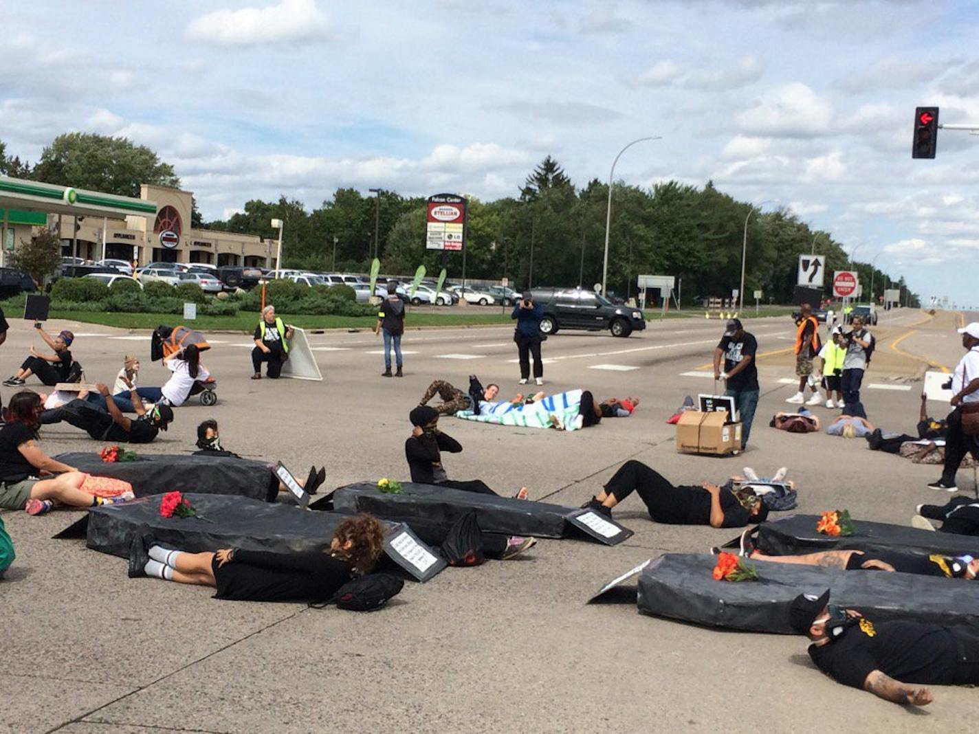 Protesters hold a die-in at the intersection of Snelling and Larpenteur avenues in St. Paul in honor of Philando Castile.