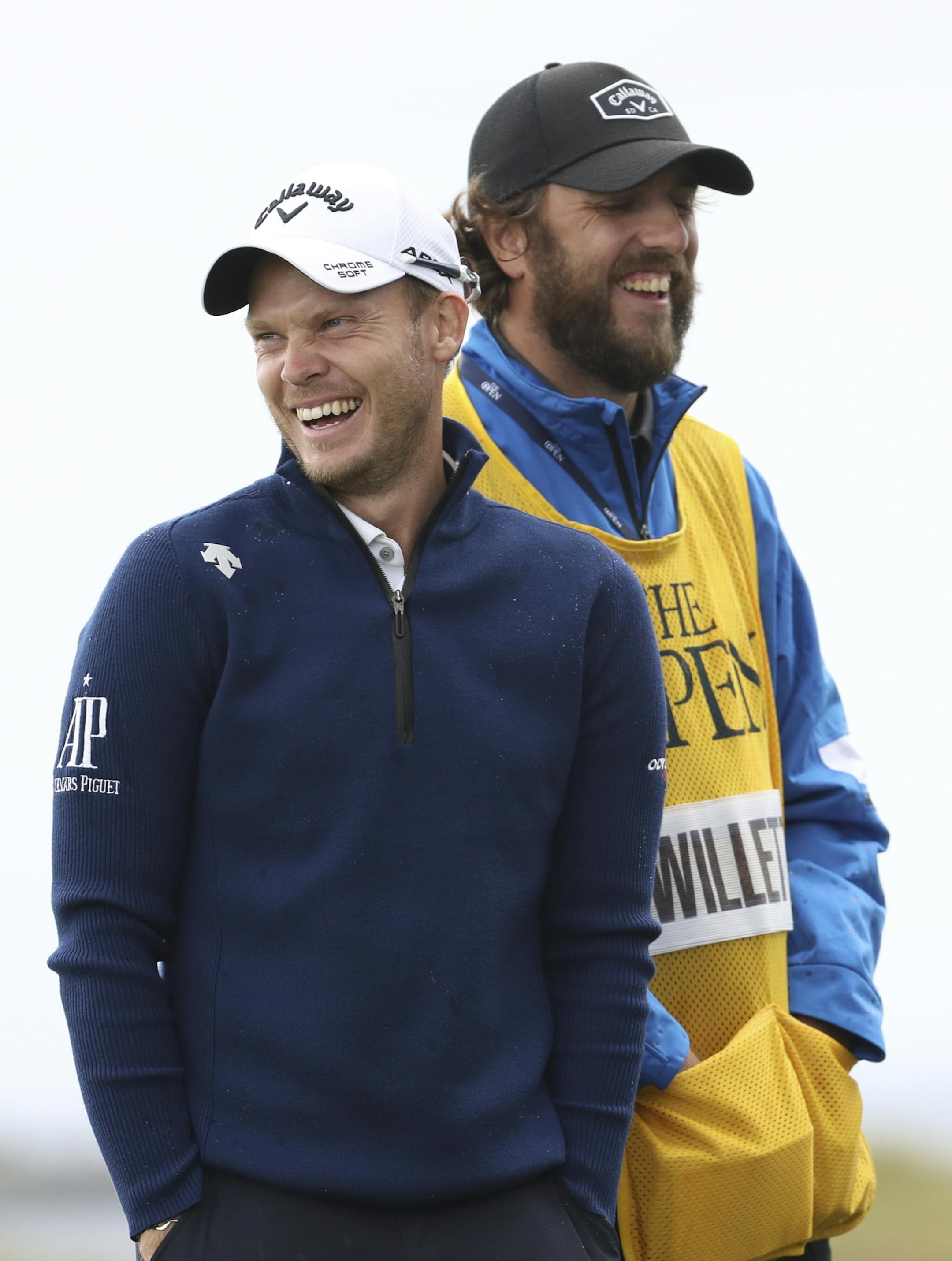 England's Danny Willett, left, smiles with Jordan Spieth of the United States as they wait to play on the 16th tee during the first round of the British Open Golf Championships at Royal Portrush in Northern Ireland, Thursday, July 18, 2019.(AP Photo/Peter Morrison)
