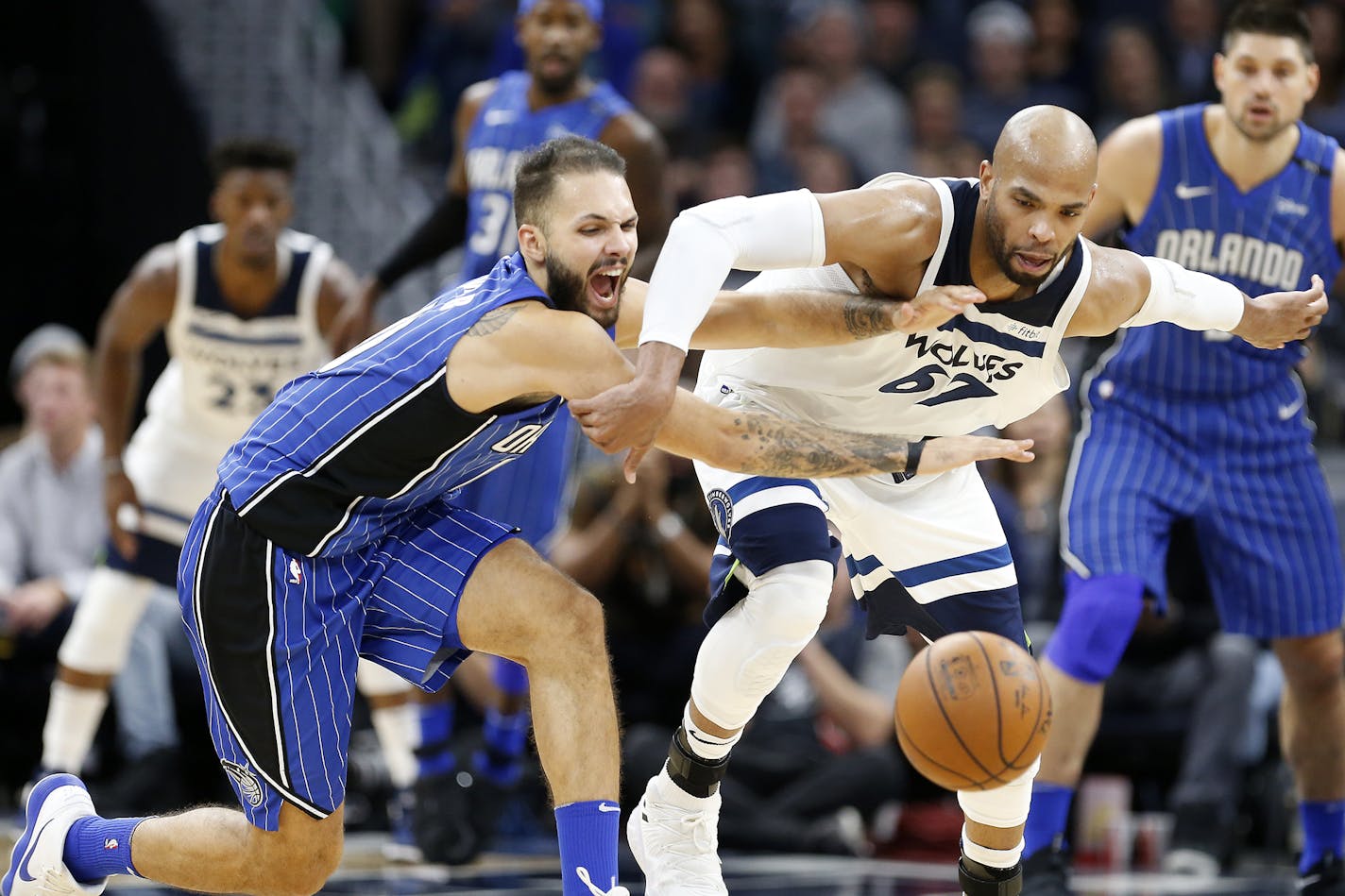 Minnesota Timberwolves forward Taj Gibson (67) and Orlando Magic forward Evan Fournier (10) chase a loose ball during the second half. ] LEILA NAVIDI &#xef; leila.navidi@startribune.com BACKGROUND INFORMATION: Minnesota Timberwolves against Orlando Magic at Target Center in Minneapolis on Wednesday, November 22, 2017.