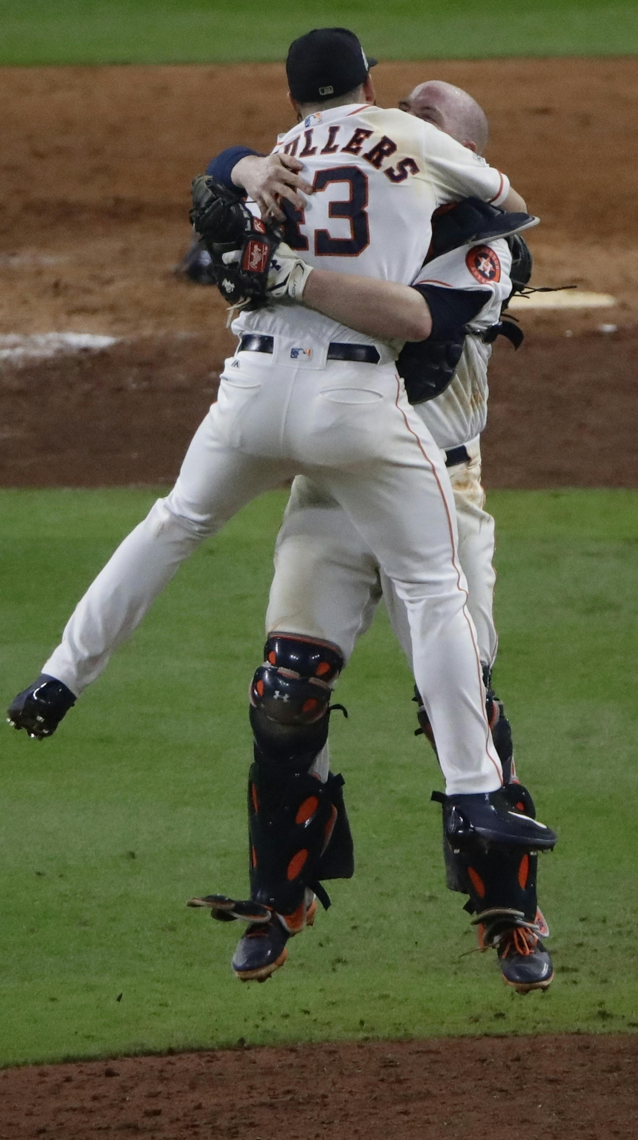 Houston Astros' Lance McCullers Jr. leaps in the arms of Brian McCann after Game 7 of baseball's American League Championship Series against the New York Yankees Saturday, Oct. 21, 2017, in Houston. The Astros won 4-0 to win the series. (AP Photo/Charlie Riedel)