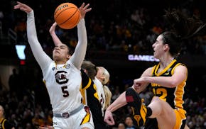 Tessa Johnson (5) grabs a rebound in front of Iowa guard Caitlin Clark (22) during the women's Final Four title game. Johnson led South Carolina with