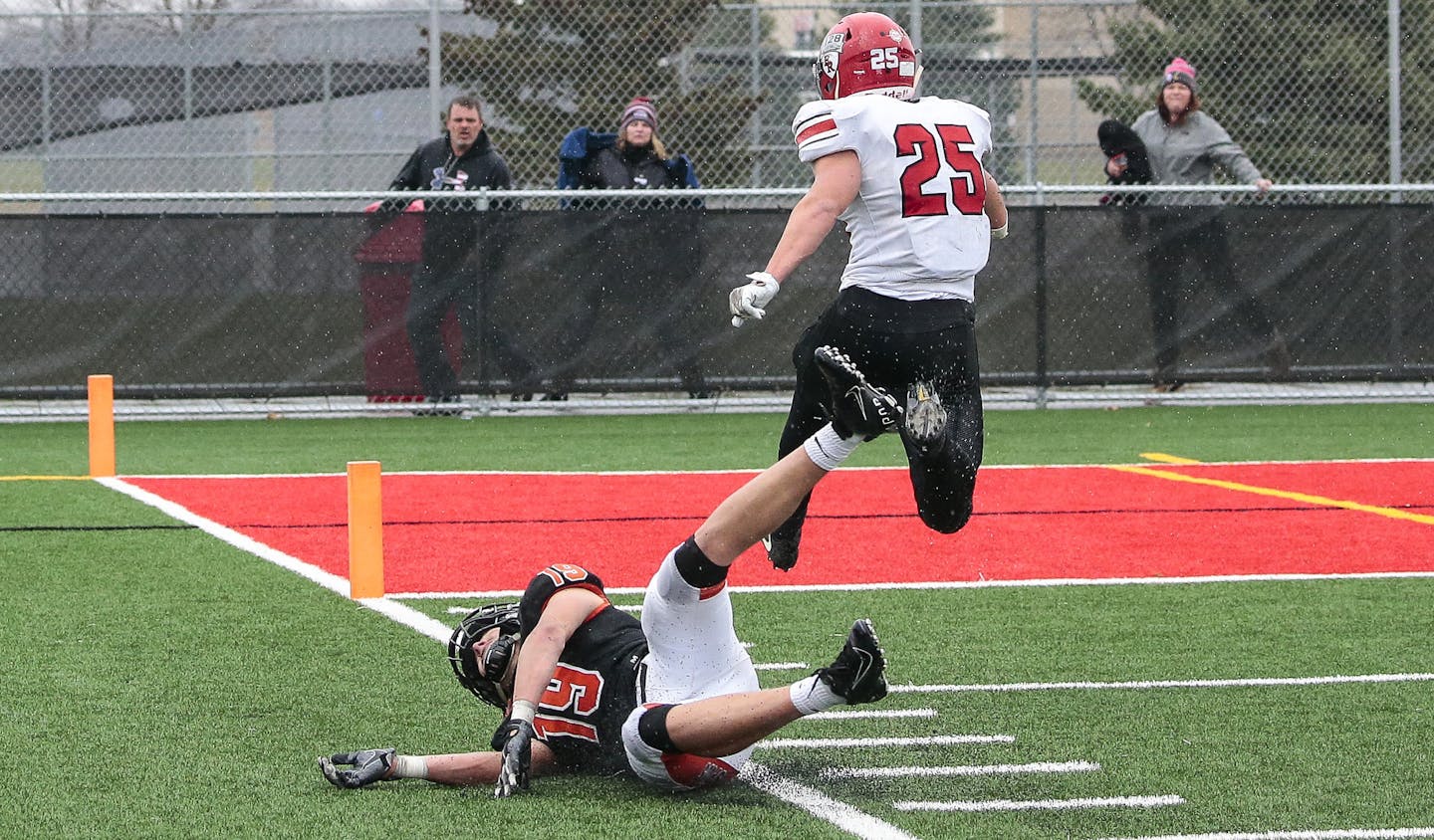 Elk River quarterback Beau Ruby completed the only pass he threw all game, connecting with teammate Carter Otto (25) for a game-winning 57-yard touchdown in the final seconds of a Class 5A quarterfinal game for a 58-55 victory against Moorhead on Nov. 9 at Monticello High School. Photo by Cheryl A. Myers, SportsEngine