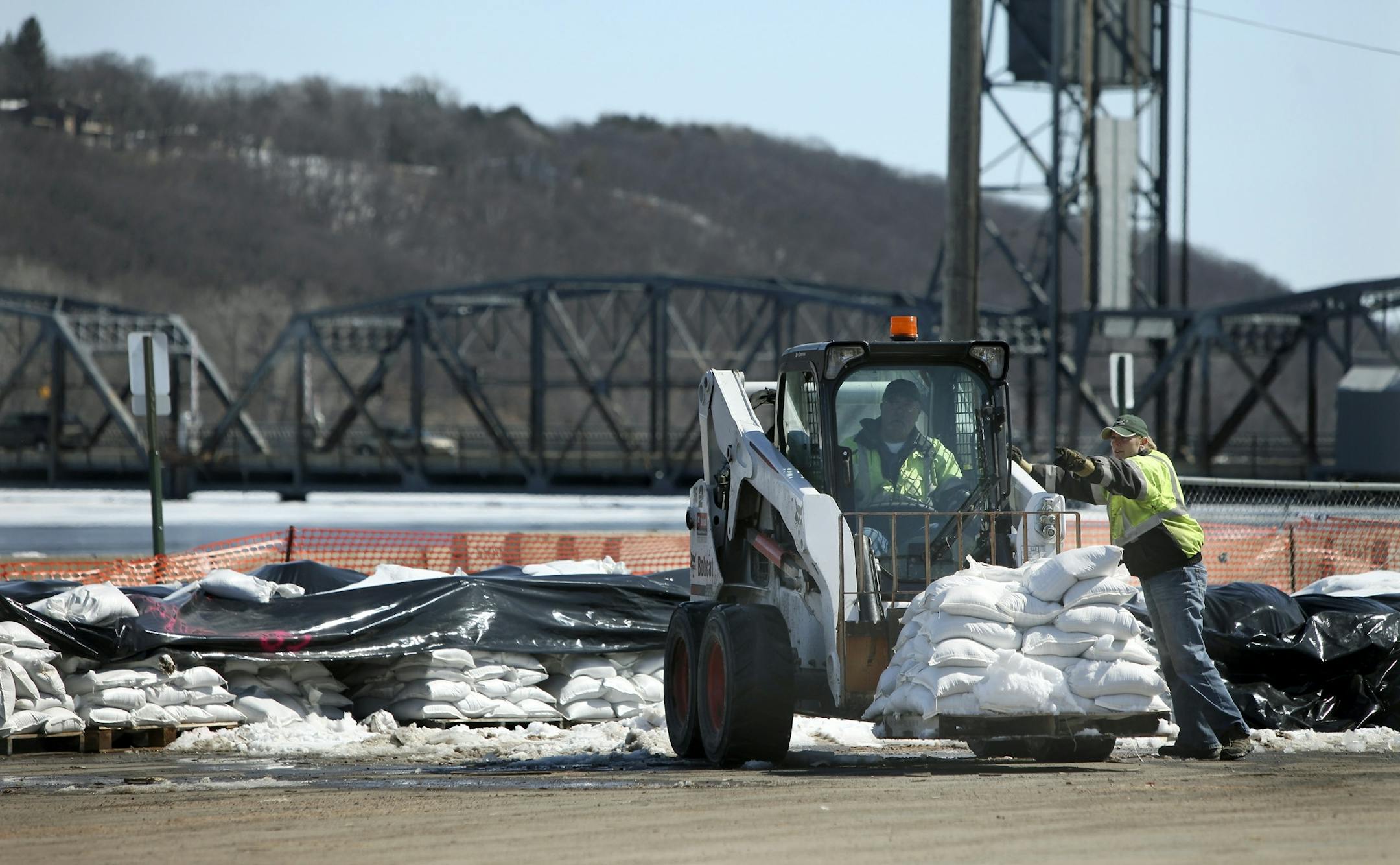 Stillwater city crew worked on moving sand bags along the downtown river walk. It is flooded and the lift bridge may close.