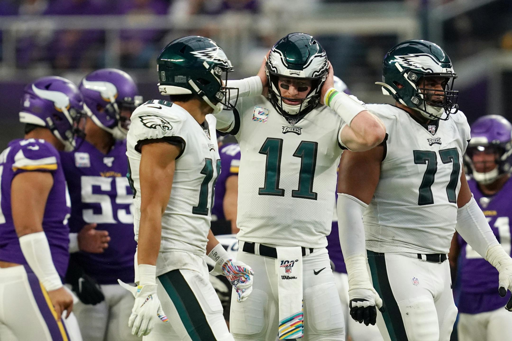Philadelphia Eagles quarterback Carson Wentz (11) covered his ears as he tired to hear his headset in the fourth quarter.