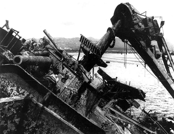 In this May 24, 1943, photo, the capsized battleship USS Oklahoma is lifted out of the water at Pearl Harbor in Honolulu.