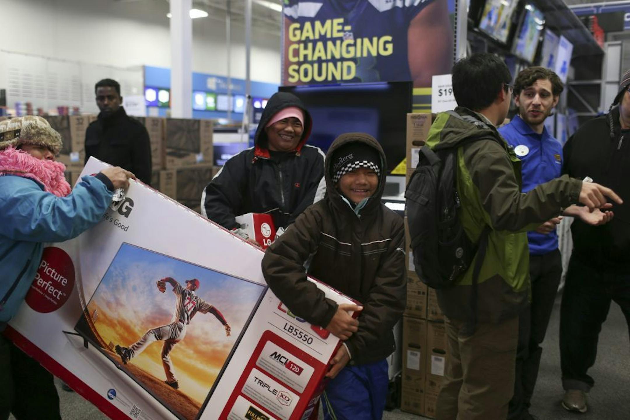 A family carried two flat-screen televisions toward checkout shortly after the Roseville Best Buy store opened Thursday evening.