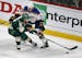 The Minnesota Wild's Jason Zucker (16) and the St. Louis Blues' Jay Bouwmeester (19) battle for the puck in the first period of Game 1 of the Western 