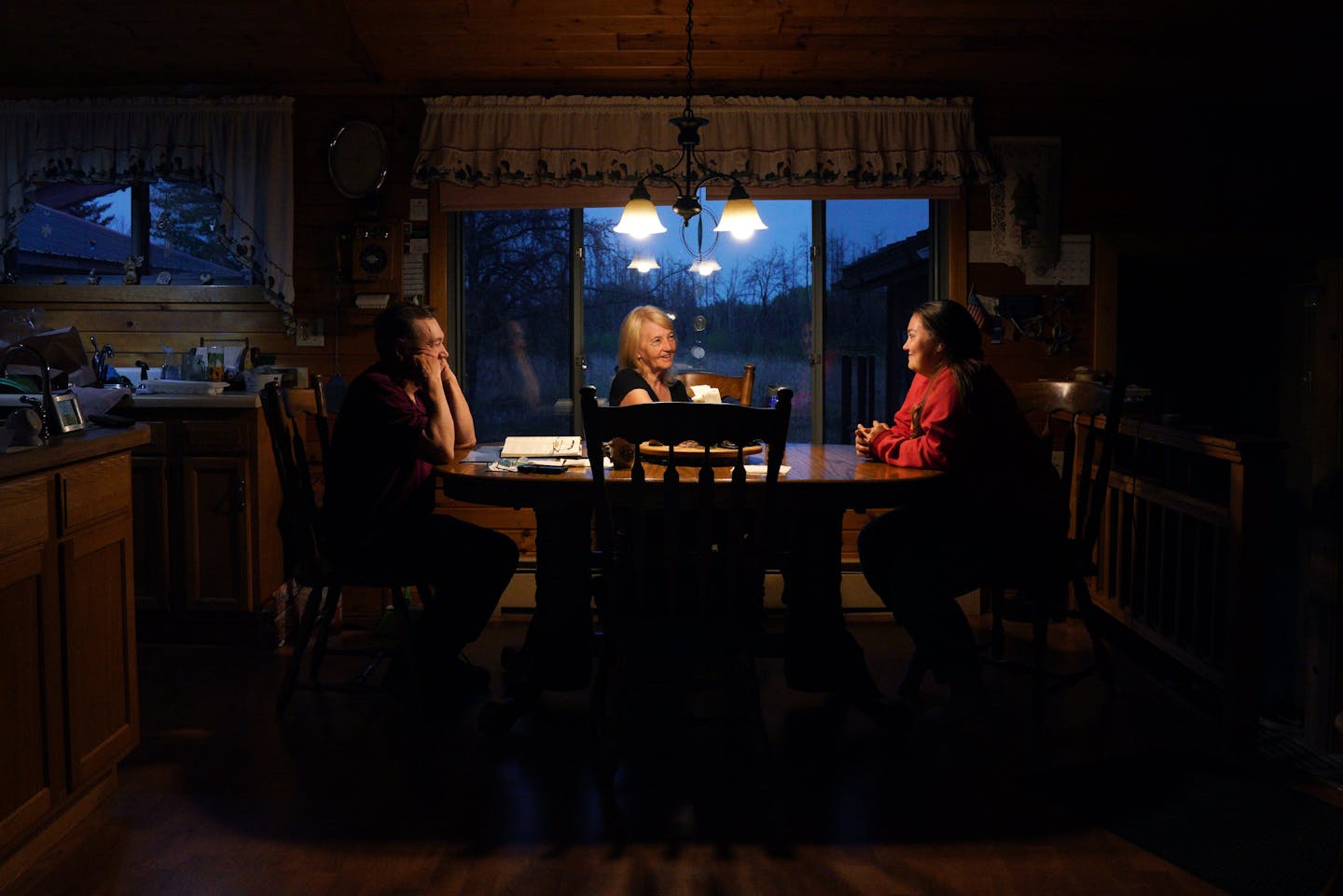 Joe and Diane Fondie, above, talked with their granddaughter, illuminated by a single light fixture, at their part-time home in Skibo, Minn., a village with no electric service.