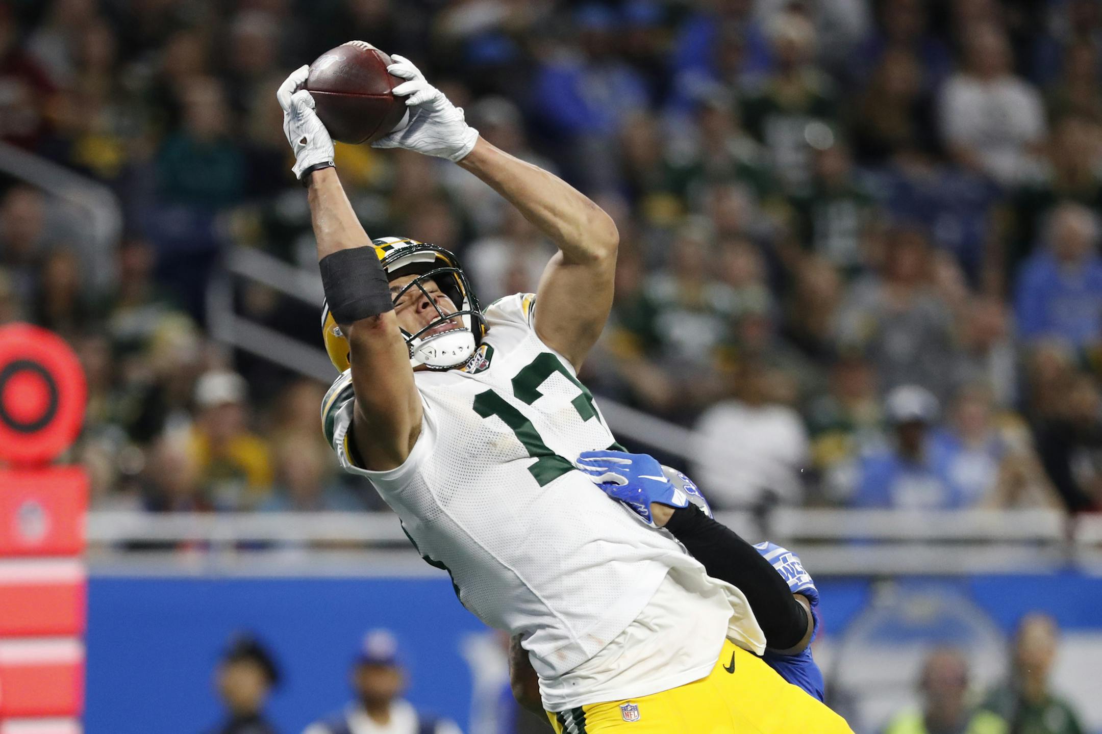 Green Bay Packers wide receiver Allen Lazard (13), defended by Detroit Lions cornerback Darius Slay, catches a 28-yard pass for a touchdown during the second half of an NFL football game, Sunday, Dec. 29, 2019, in Detroit. (AP Photo/Rick Osentoski)