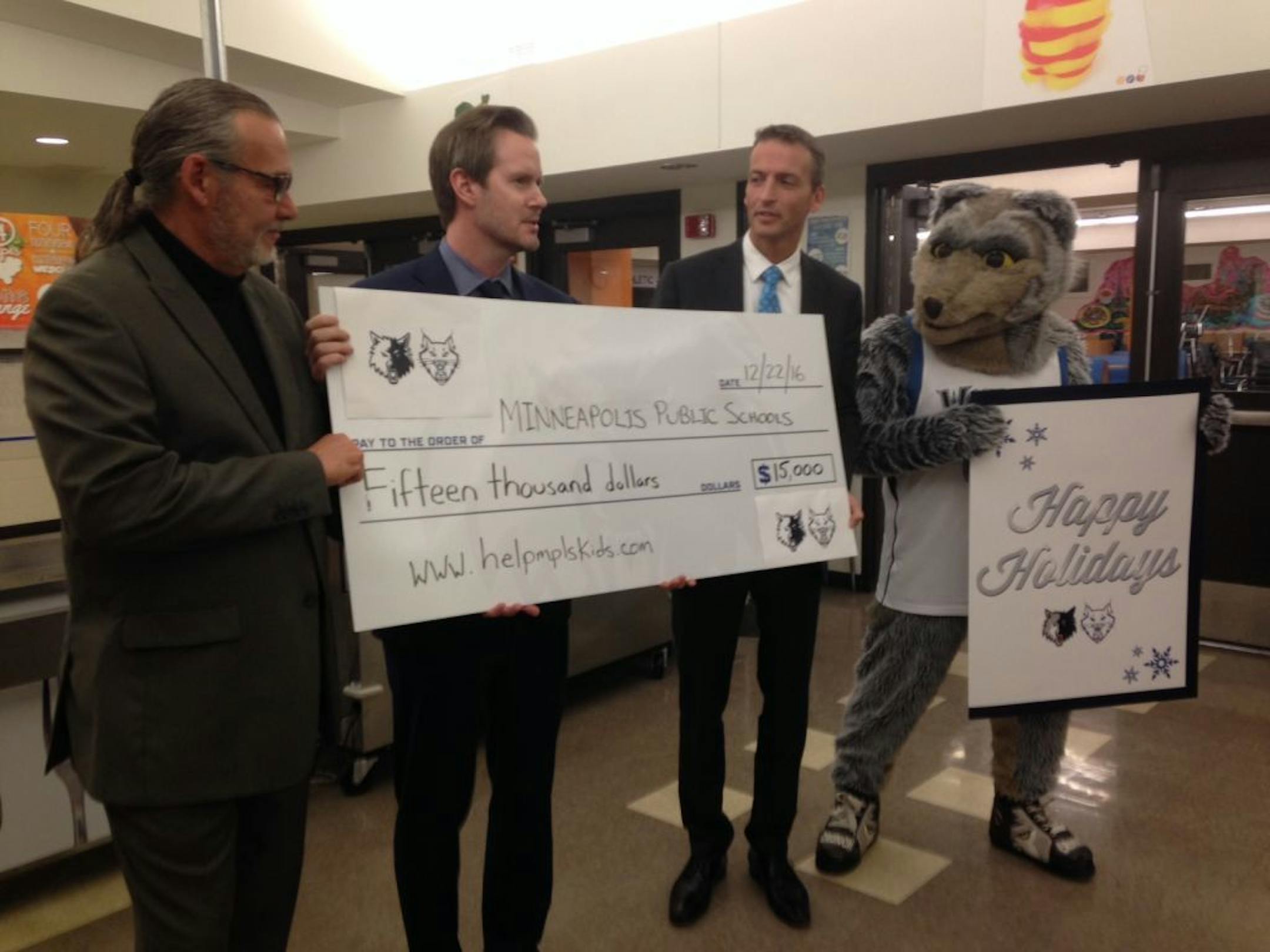 Ethan Casson (second from left), Minnesota Timberwolves and Lynx CEO, presented a $15,000 check to Minneapolis Public Schools Superintendent Ed Graff (right) and director of culinary and wellness services Bertrand Weber (left) from the staffs of the two teams. It is a contribution to outstanding student lunch accounts.