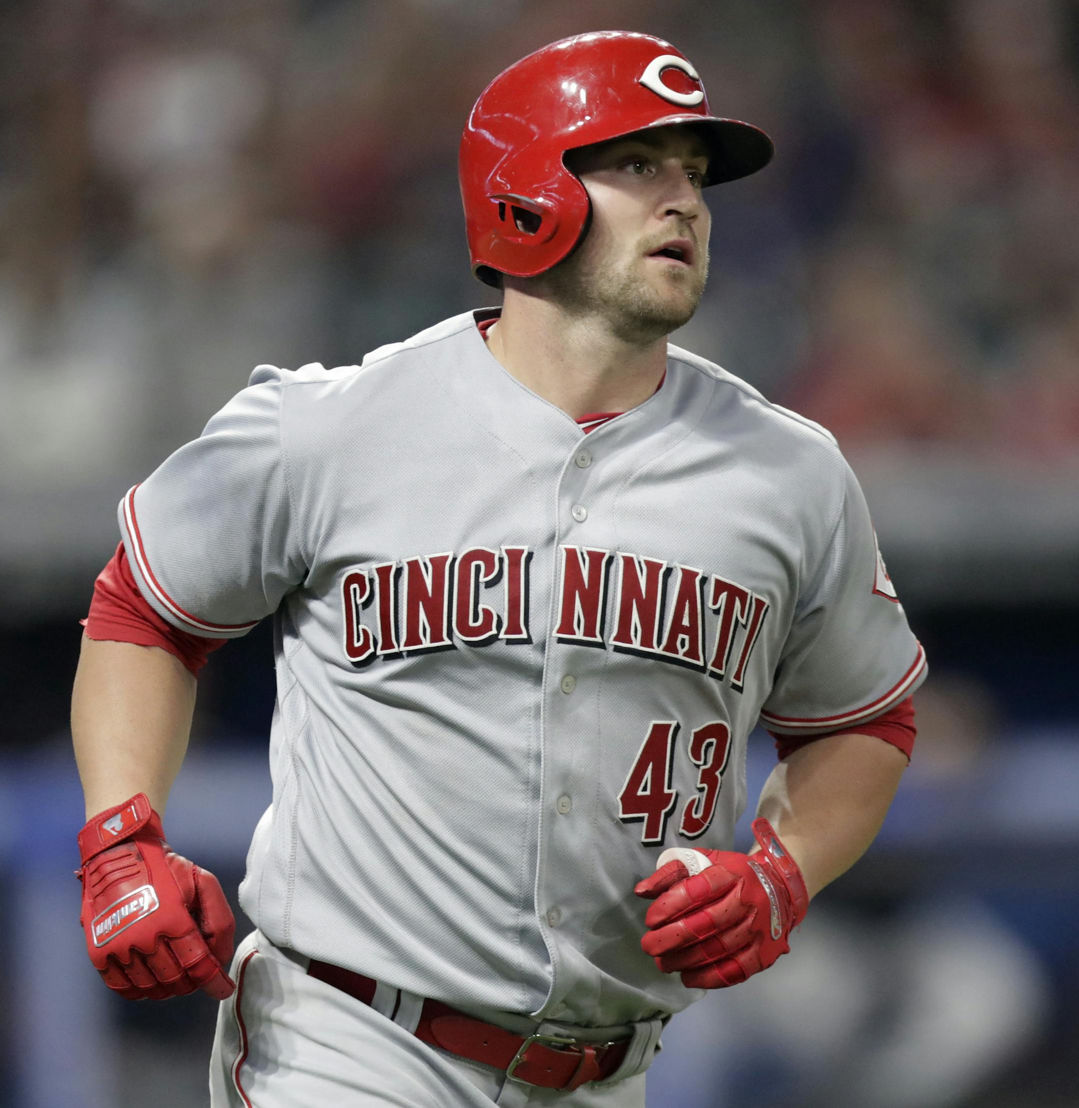 Cincinnati Reds' Scott Schebler watches his ball after hitting a two-run home run in the ninth inning of a baseball game against the Cleveland Indians, Monday, July 9, 2018, in Cleveland. Billy Hamilton scored on the play. (AP Photo/Tony Dejak)