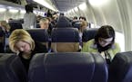 All of the middle seats were empty and Judy Blazek, foreground left, and Caley Gregg, right, were among only 51 passengers who boarded Southwest Airli