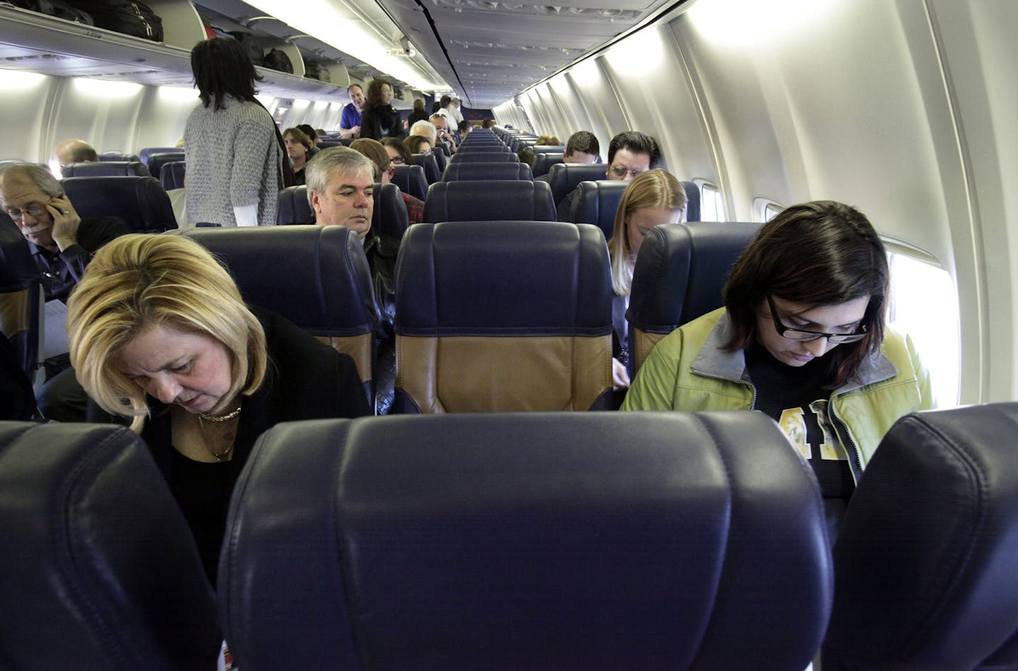 All of the middle seats were empty and Judy Blazek, foreground left, and Caley Gregg, right, were among only 51 passengers who boarded Southwest Airlines flight 907 for a morning flight departing Love Field in Dallas to San Antonio on January 6, 2011. Short-haul routes, the lifeblood of Southwest Airlines, are no longer a profitable as they used to be. (Jim Mahoney/Dallas Morning News/MCT) ORG XMIT: 1099507