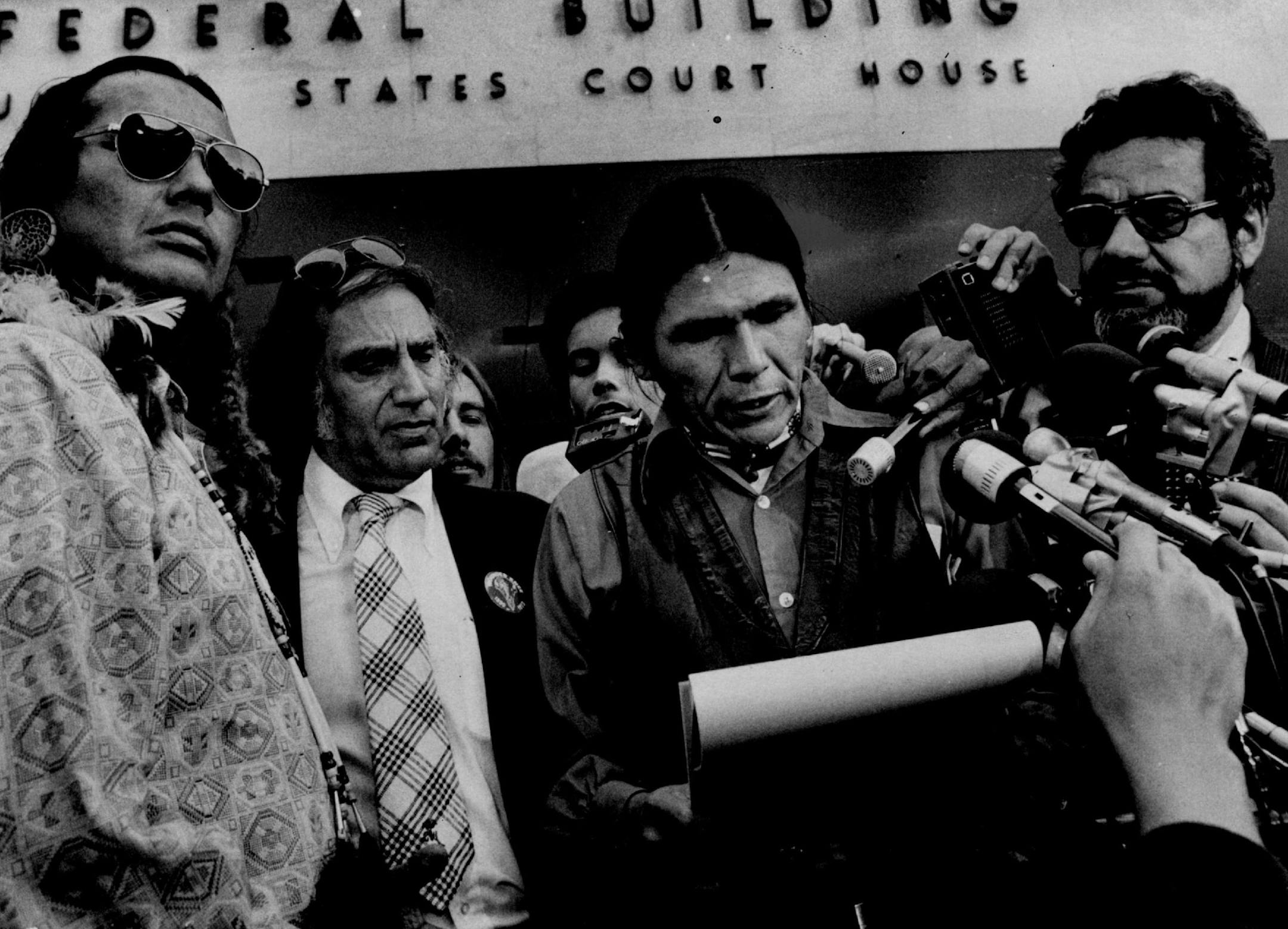 September 17, 1974: Dennis Banks, reads a statement to reporters after all charges against him and Russell Means (left) were dismissed by U.S. District Judge Fred Nichol yesterday.