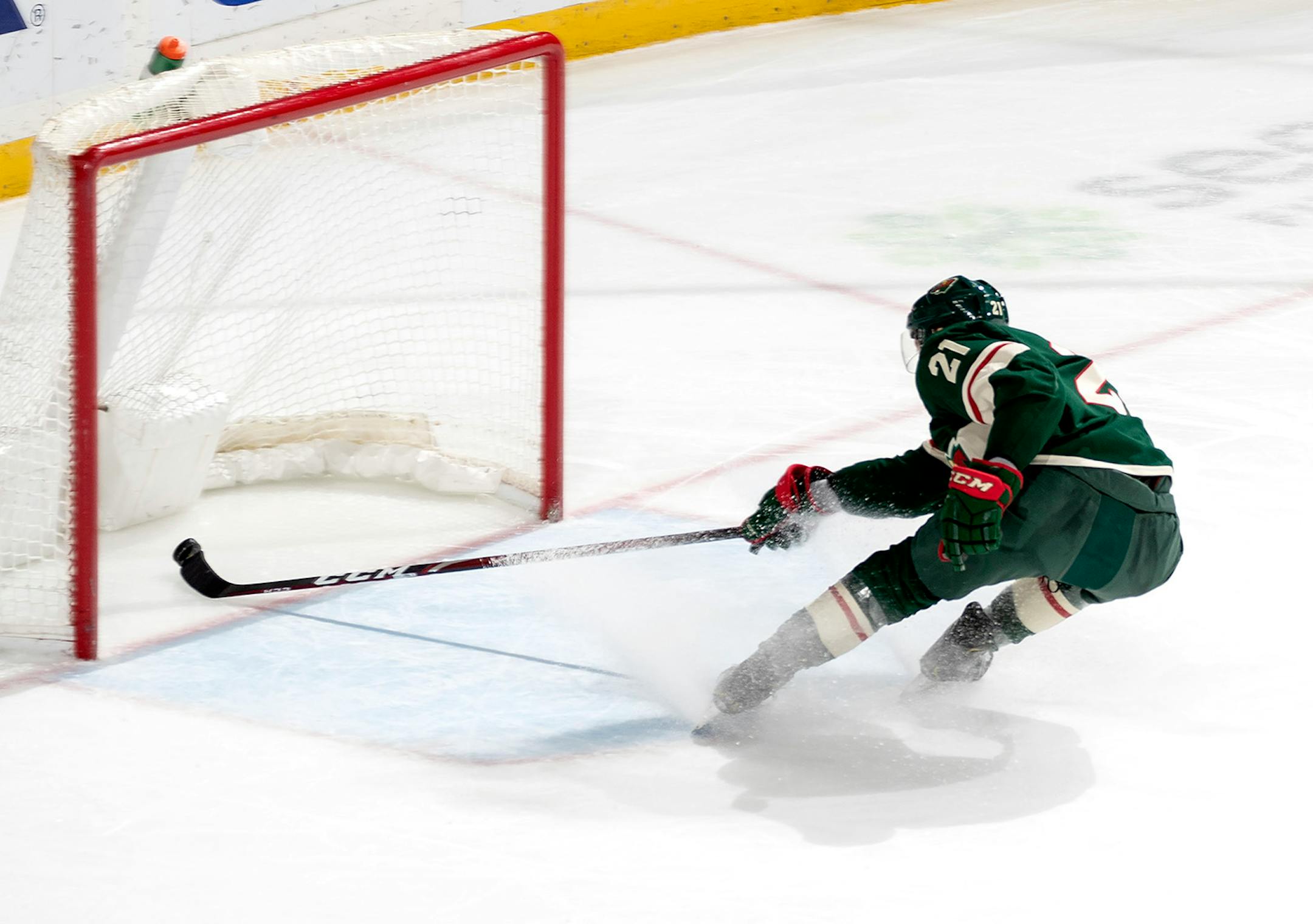 Carson Soucy (21) of the Minnesota Wild could not stop the puck from entering an empty net for a goal by Christopher Tanev (8) of the Vancouver Canucks in the third period.