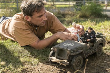 Steve Carell as Mark Hogancamp photographs the dolls for his fictional town in "Welcome to Marwen," directed by Robert Zemeckis.