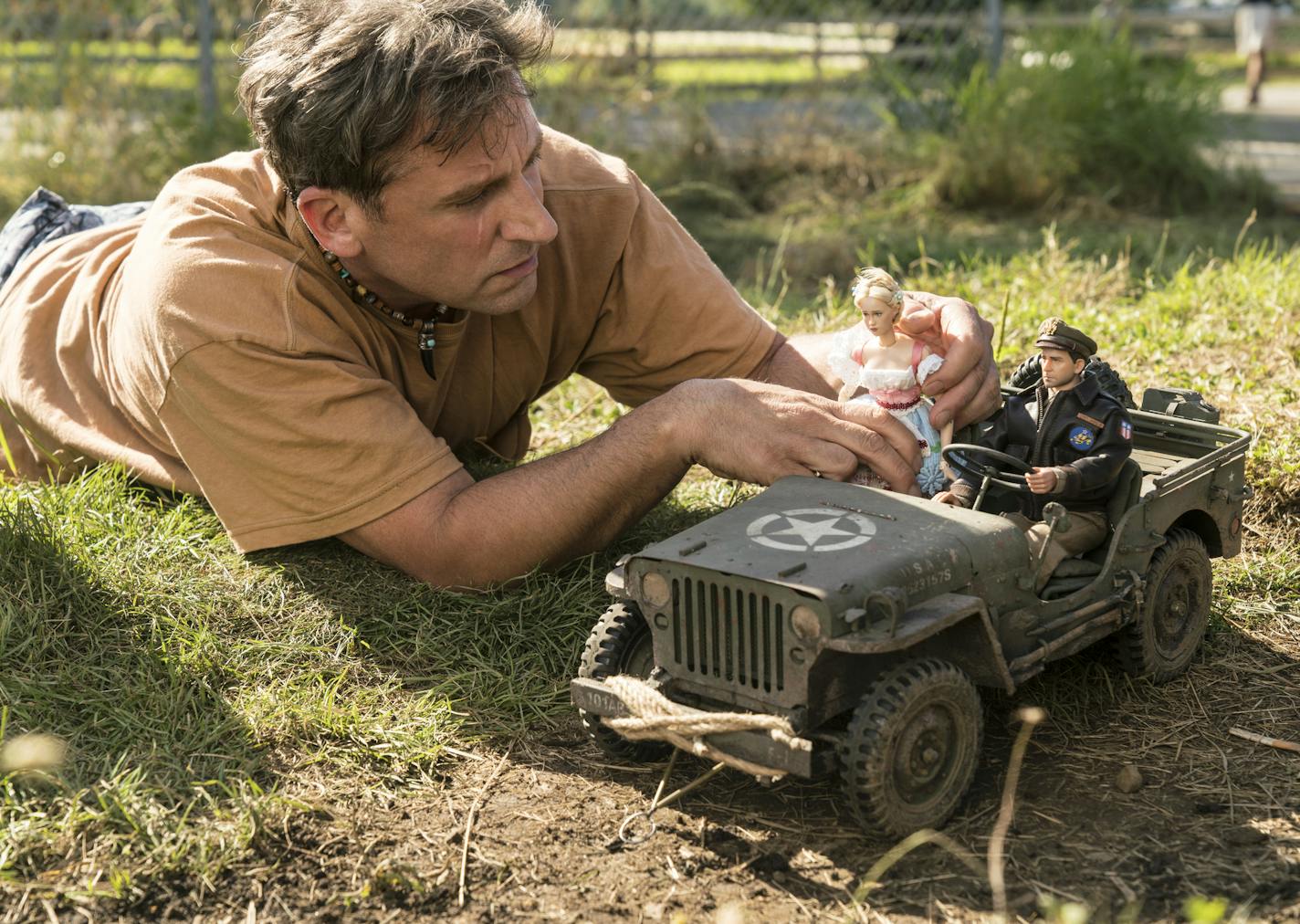 Steve Carell as Mark Hogancamp photographs the dolls for his fictional town in "Welcome to Marwen," directed by Robert Zemeckis.