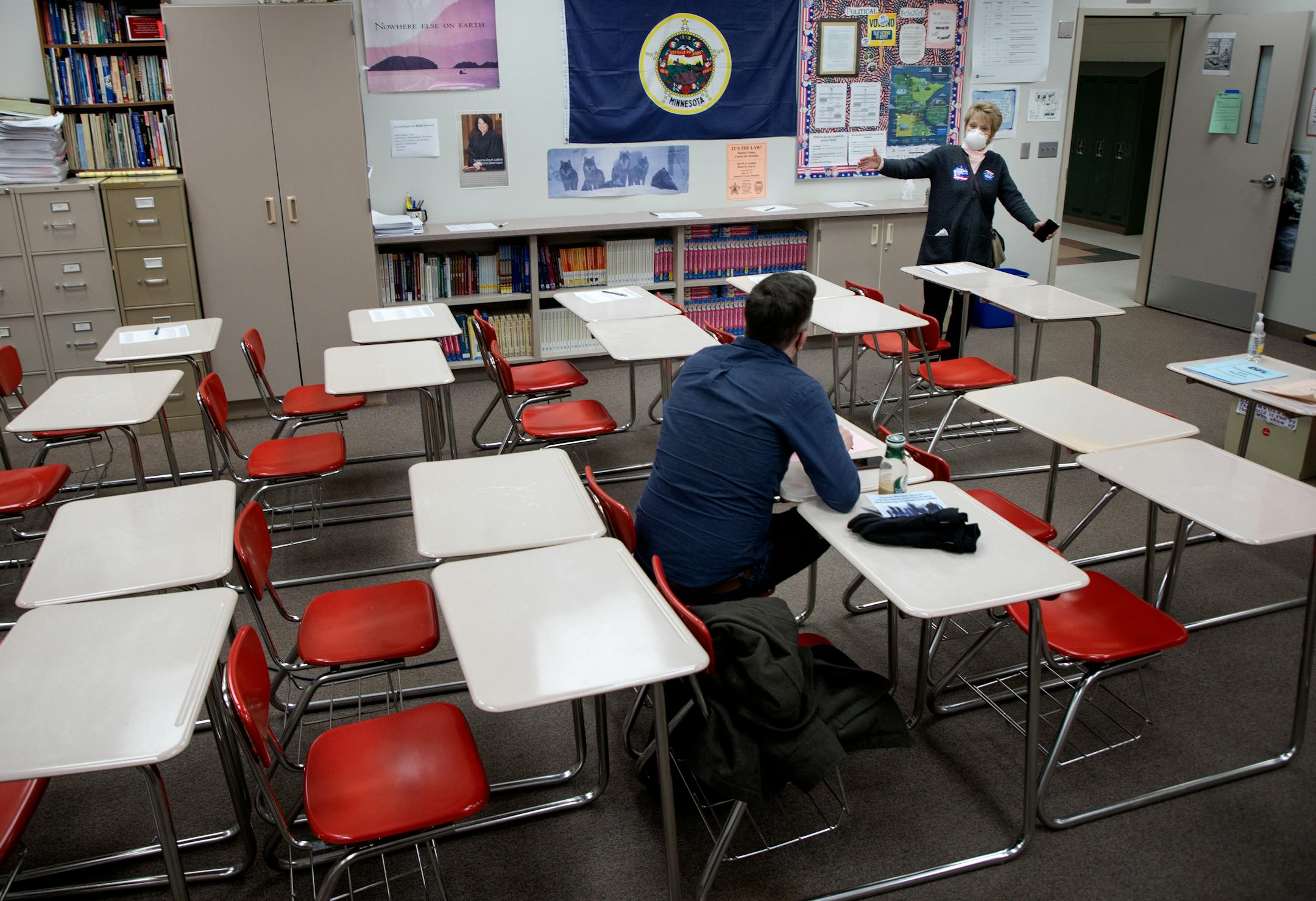 State Senate candidate Nancy Livingston speaks to a resident from North St. Paul precinct 2 during a DFL caucus Tuesday, Feb. 1, at North High School in North Saint Paul, Minn. ] CARLOS GONZALEZ • cgonzalez@startribune.com