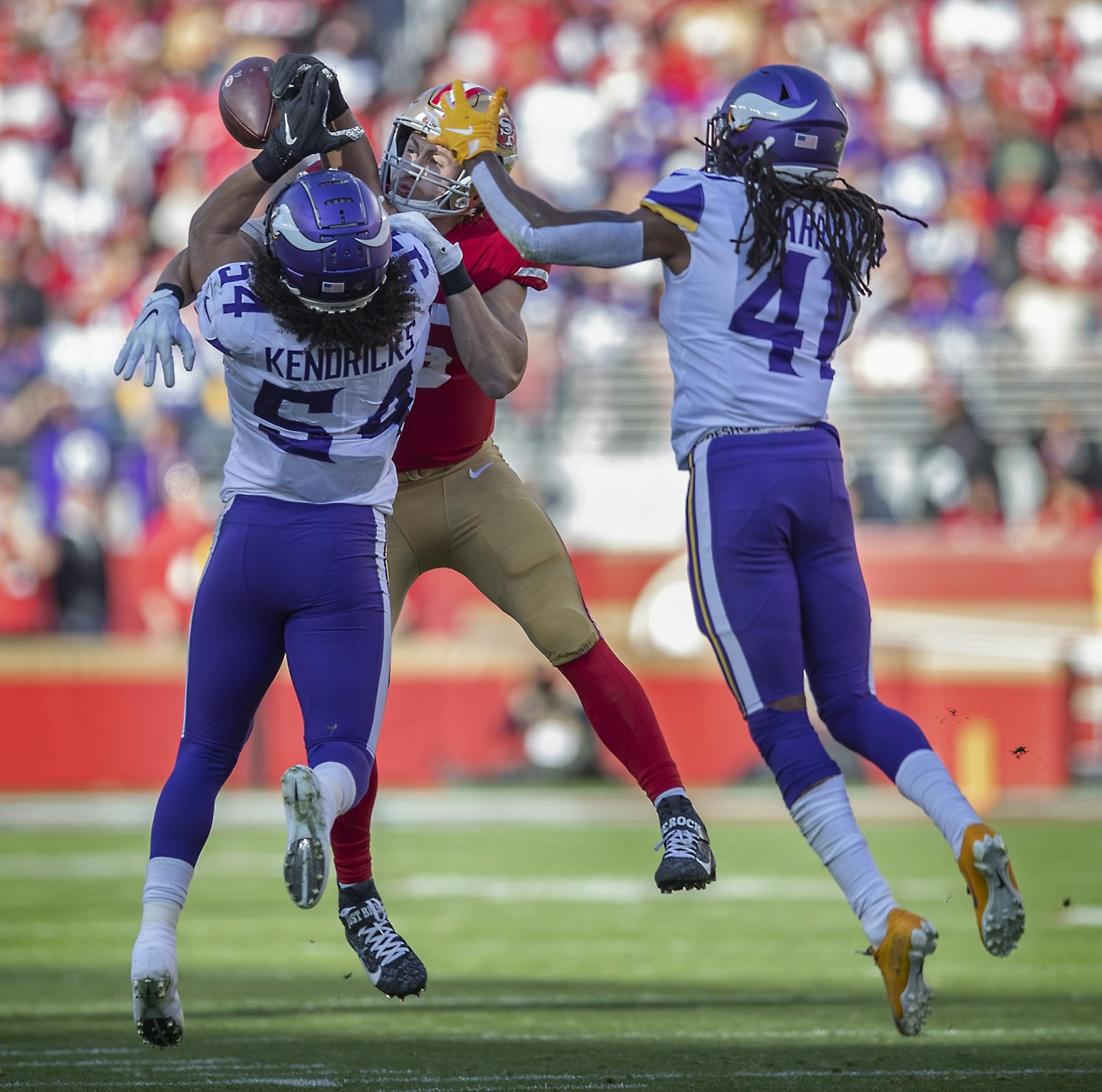 Minnesota Vikings middle linebacker Eric Kendricks and Minnesota Vikings defensive back Anthony Harris stopped a pass intended for San Francisco 49ers tight end George Kittle in the first quarter.