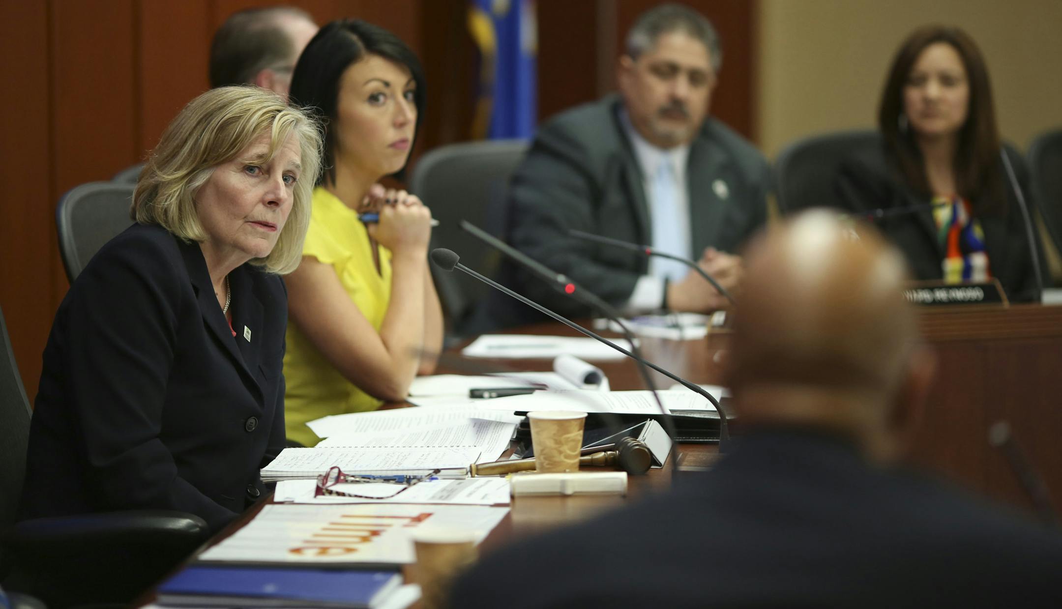 Susan Haigh, chair of the Metropolitan Council, left, listened to comments by council member Gary Cunningham before she called for a vote on the Southwest Corridor light-rail project.