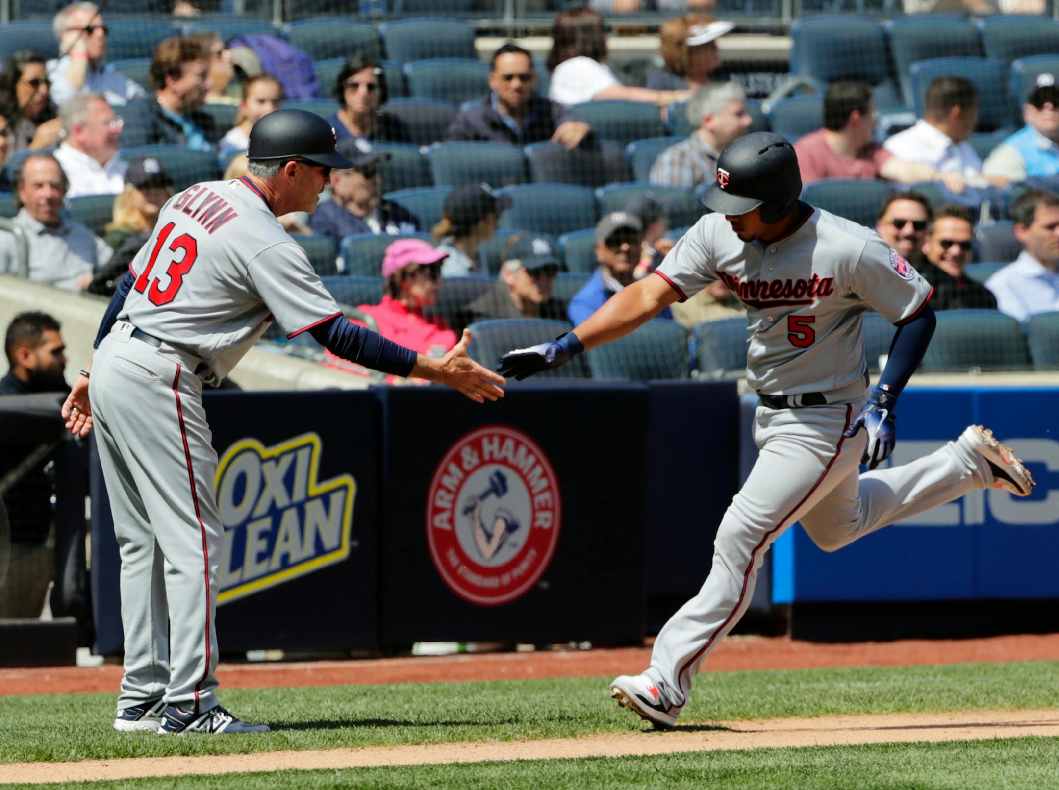 Minnesota Twins' Eduardo Escobar (5) celebrates with third base coach Gene Glynn (13) as he runs the bases after hitting a two-run home run during the third inning of a baseball game against the New York Yankees Thursday, April 26, 2018, in New York. (AP Photo/Frank Franklin II)