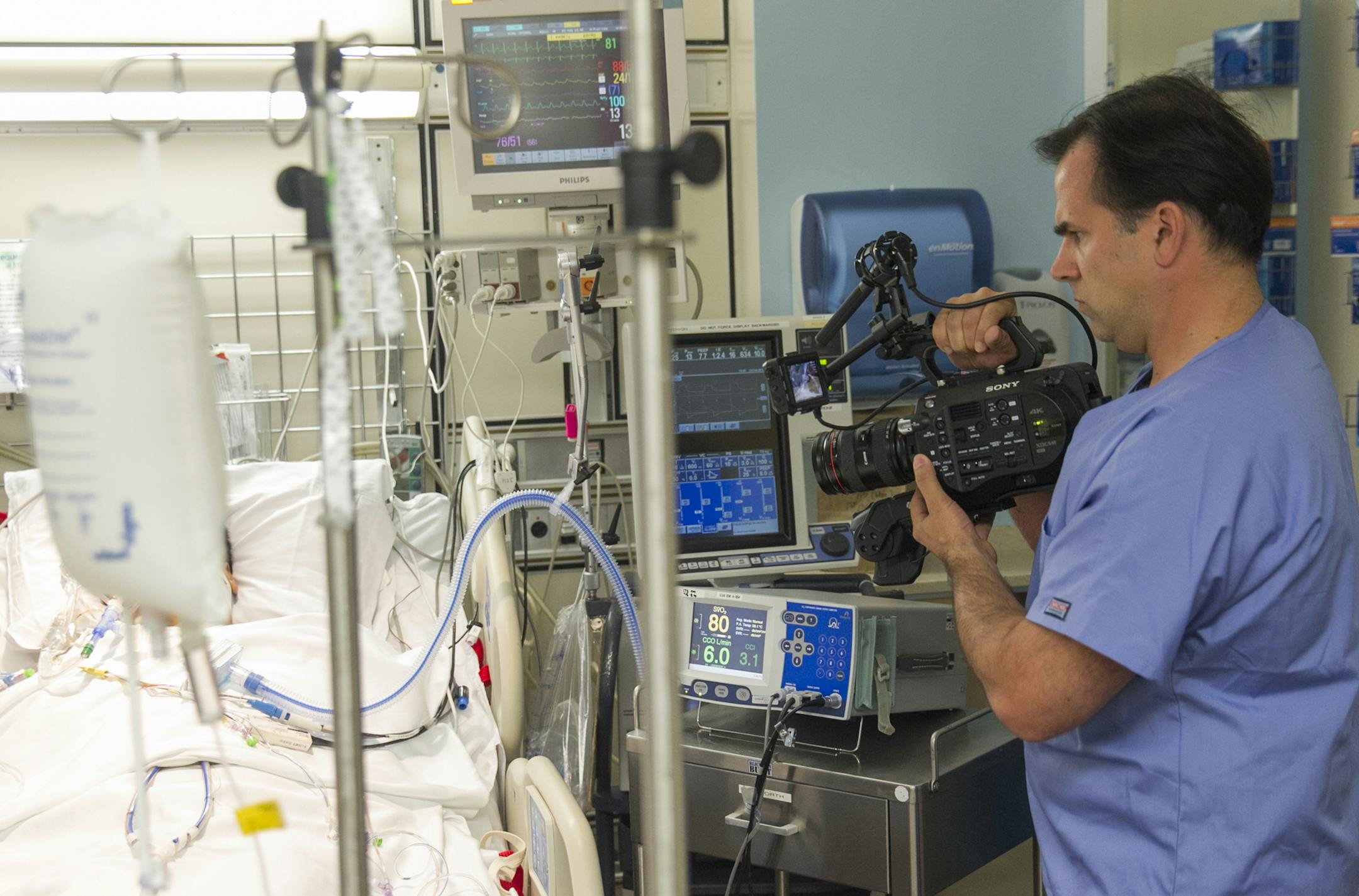 In this photo taken Feb. 23, 2015, Dr. Angelo Volandes films a patient at Straub Clinic and Hospital in Honolulu, for videos he develops that educate families about end-of-life care options, such as CPR. The Institute of Medicine is pushing for more patients to have conversations with their doctors about their end-of-life wishes, and programs such as Volandes' videos are one tool to get the discussion started. Volandes, a Harvard internist, creates videos that lay out facts about such things as