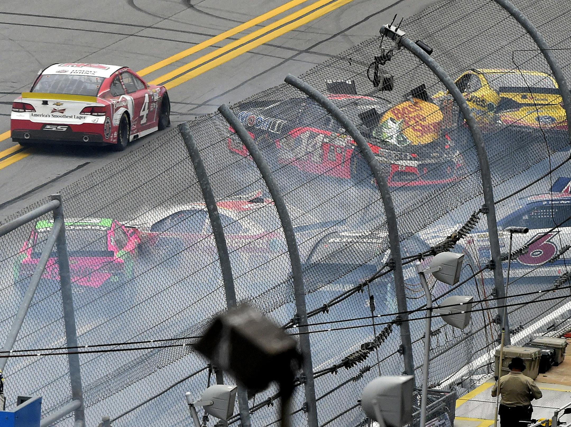 Sprint Cup Series driver Kevin Harvick (4) drives past a wreck involving Sprint Cup Series driver Tony Stewart (14), David Gilliland (38), Danica Patrick (10) Trevor Bayne (6) during the NASCAR Sprint Cup Series auto race at Talladega Superspeedway Sunday, Oct. 25, 2015, in Talladega, Ala. (AP Photo/ Mark Almond )