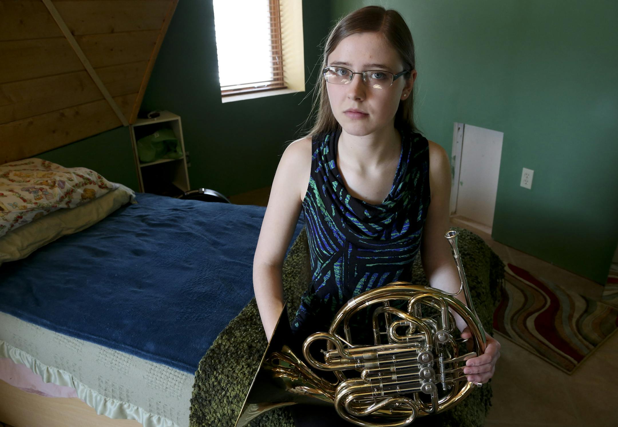 Anessa DeMers, a senior at Elk River High School, sat in her room with her French horn, one of three instruments she plays at her home in Nowthen, Min., Thursday, March 28, 2013. DeMers who is a 4.0 student and had a perfect score on her ACT will not qualify for valedictorian because of how classes in this school have different values. ] (KYNDELL HARKNESS/STAR TRIBUNE) kyndell.harkness@startribune.com