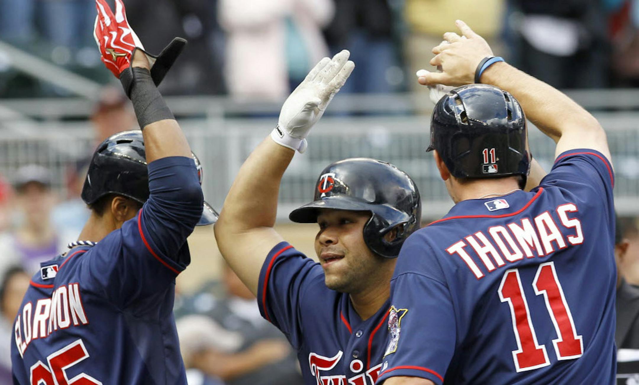Minnesota's Pedro Florimon (25) and Clete Thomas (11) congratulate Josmil Pinto after his game-winning three run home run off Tampa Bay relief pitcher Joel Peralta during the eighth inning Sunday.