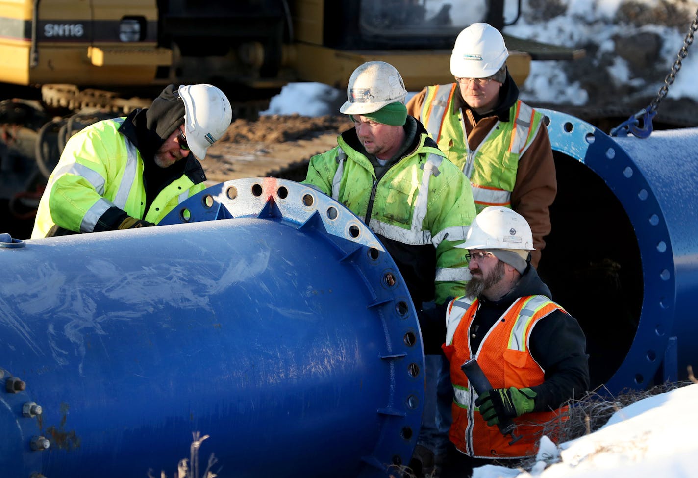 Construction crews are now setting up a large temporary wastewater pumping and piping system to convey wastewater around a large sewer under I-694 that we will repair in January. The current work involves excavation and placement of about 15 large pumps. Each day two hundred and fifty million gallons of water and waste is pumped through the Met Council system to eight treatment plants in the metro--enough to fill the entire Empire State Building daily. Here, a crew works on the temporary piping