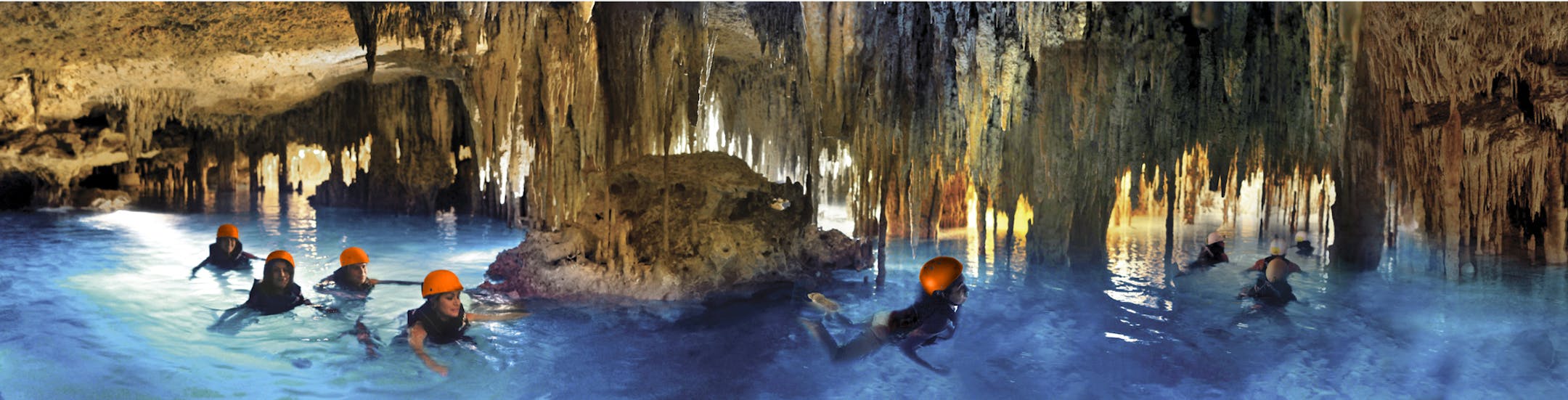 At top, rappelling makes for a dramatic entry to the subterranean world of cenotes, whose waters are clear because they have filtered through the ground. Above, visitors swim in an underground river at Xplor, an adventure park near Playa del Carmen.