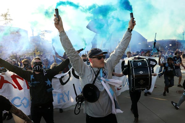 Minnesota United fans sang songs and burned blue smoke bombs as they marched into TCF Bank stadium for Saturday's night's game between the Minnesota U