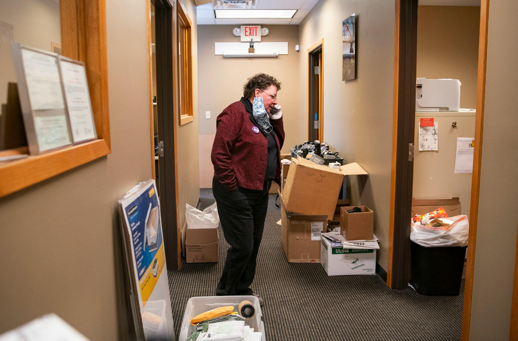 Cathy Mennes, co-owner of First Photo, paused developing film to take a phone call on Wednesday, March 31, 2021.