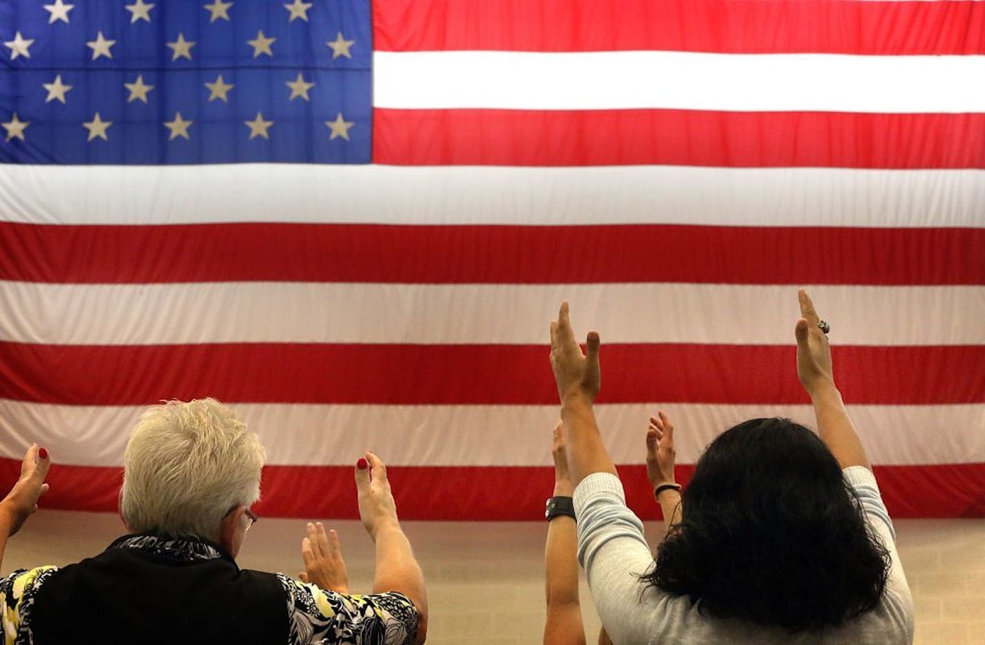 Adults participated in a Tai Ji Quan: Moving for Better Balance class taught by Dr. Fuzhong Li (not pictured) at the "Take a Stand to Prevent Falls" event held at the National Guard Armory in St. Paul.