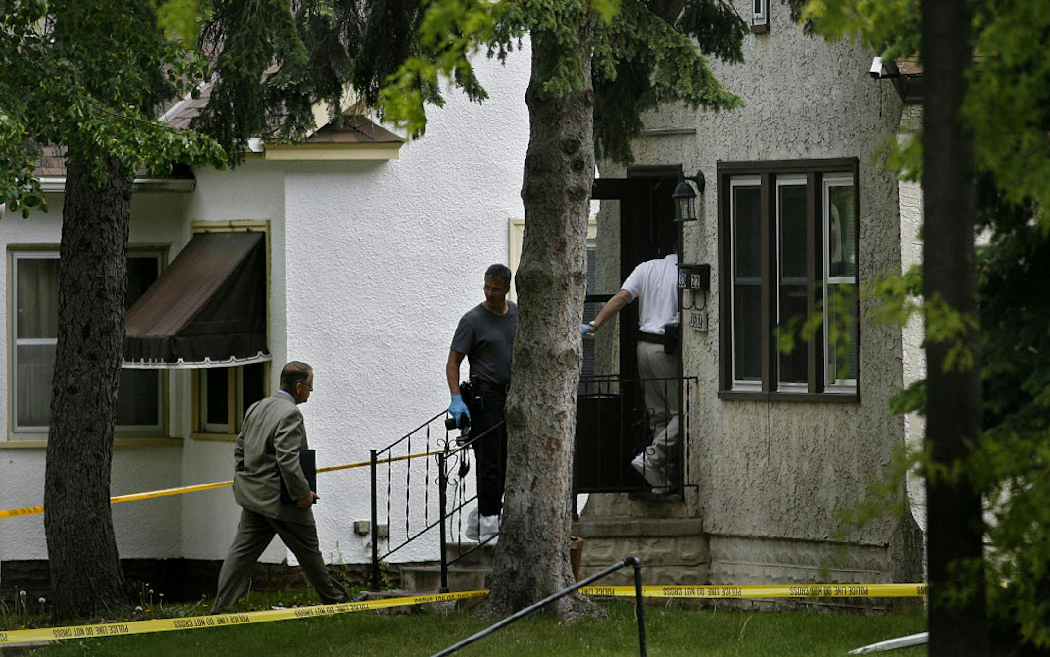 Police investigators entered a residence at 3322 N. Russell Ave. in Minneapolis, where a double homicide apparently took place.