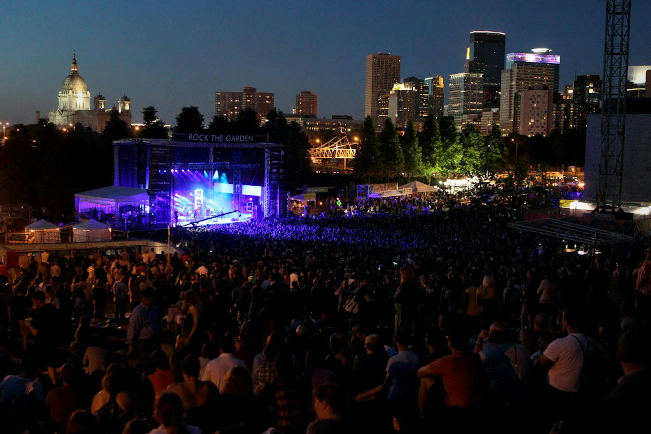 Fans atop the hill outside Walker Art Center watch Metric perform during Rock the Garden 2013.