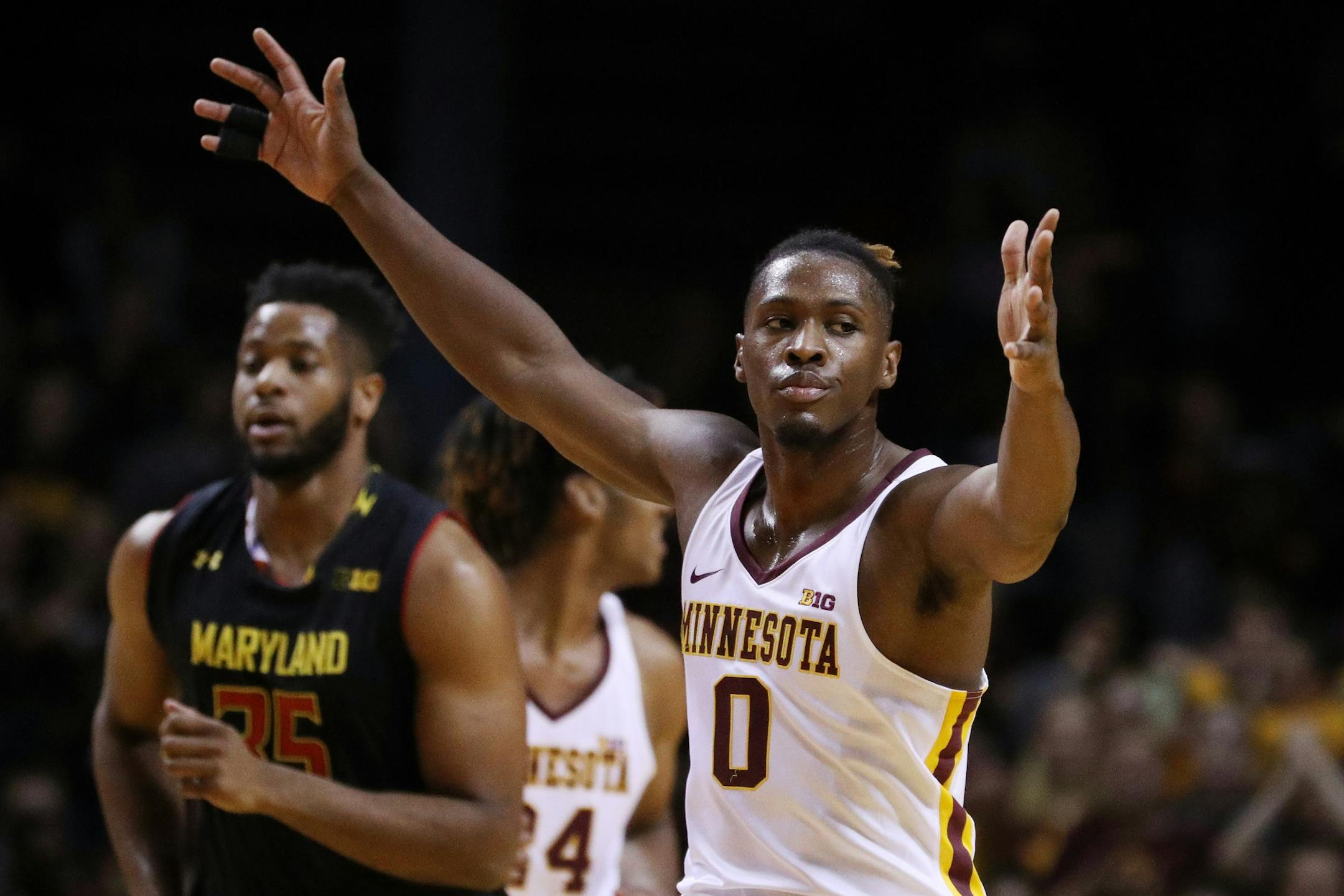Minnesota Golden Gophers guard Akeem Springs (0) reacts after dunking the ball during the first half.